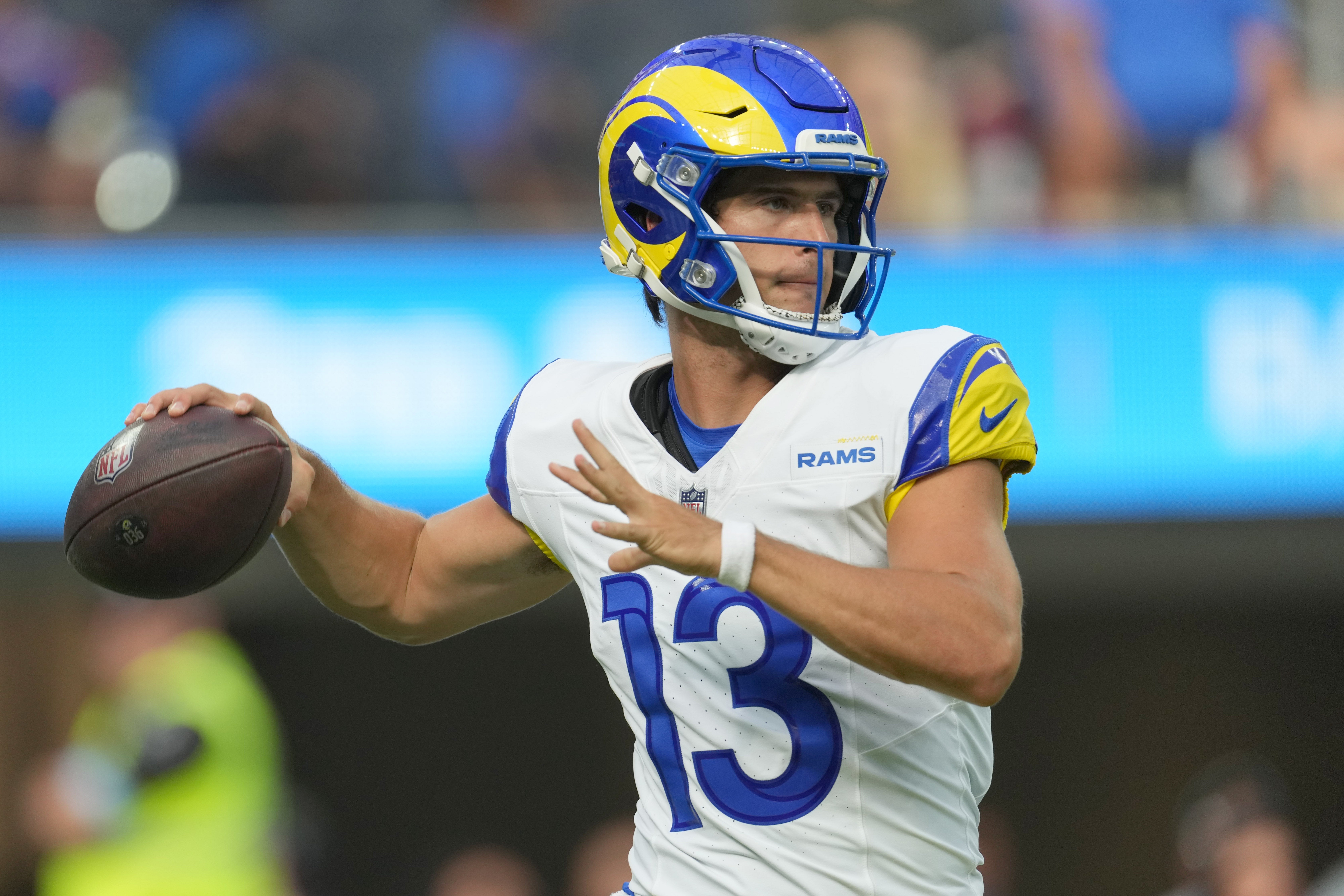 Aug 17, 2024; Inglewood, California, USA; Los Angeles Rams quarterback Stetson Bennett (13) throws the ball against the Los Angeles Chargers in the first half at SoFi Stadium