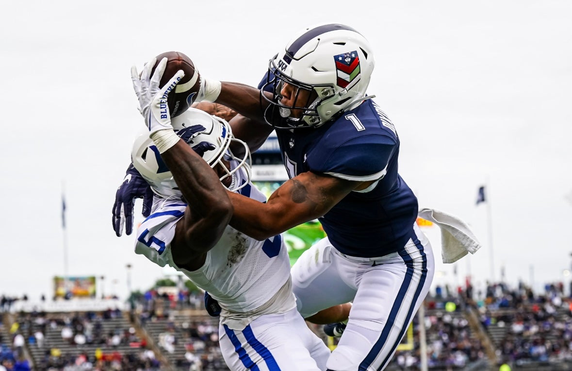 Sep 23, 2023; East Hartford, Connecticut, USA; Duke Blue Devils wide receiver Jalon Calhoun (5) makes the catch but broken up by UConn Huskies defensive back Malik Dixon-Williams (1) in the first quarter at Rentschler Field at Pratt & Whitney Stadium. Mandatory Credit: David Butler II-Imagn Images