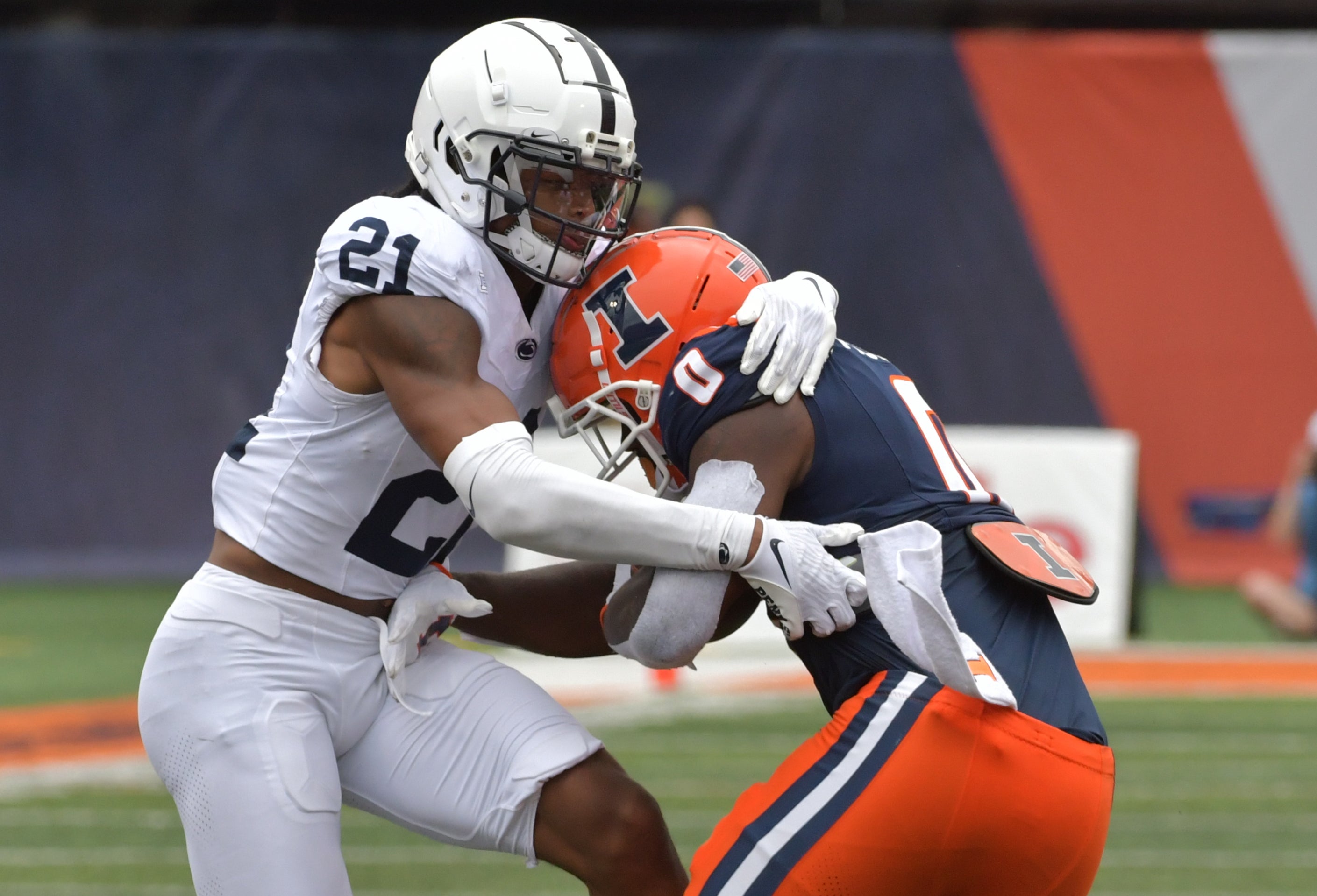 Sep 16, 2023; Champaign, Illinois, USA; Penn State Nittany Lions safety Kevin Winston Jr. (21) tackles Illinois Fighting Illini running back Josh McCray (0) after McCray caught a short pass during the second half at Memorial Stadium. Mandatory Credit: Ron Johnson-Imagn Images