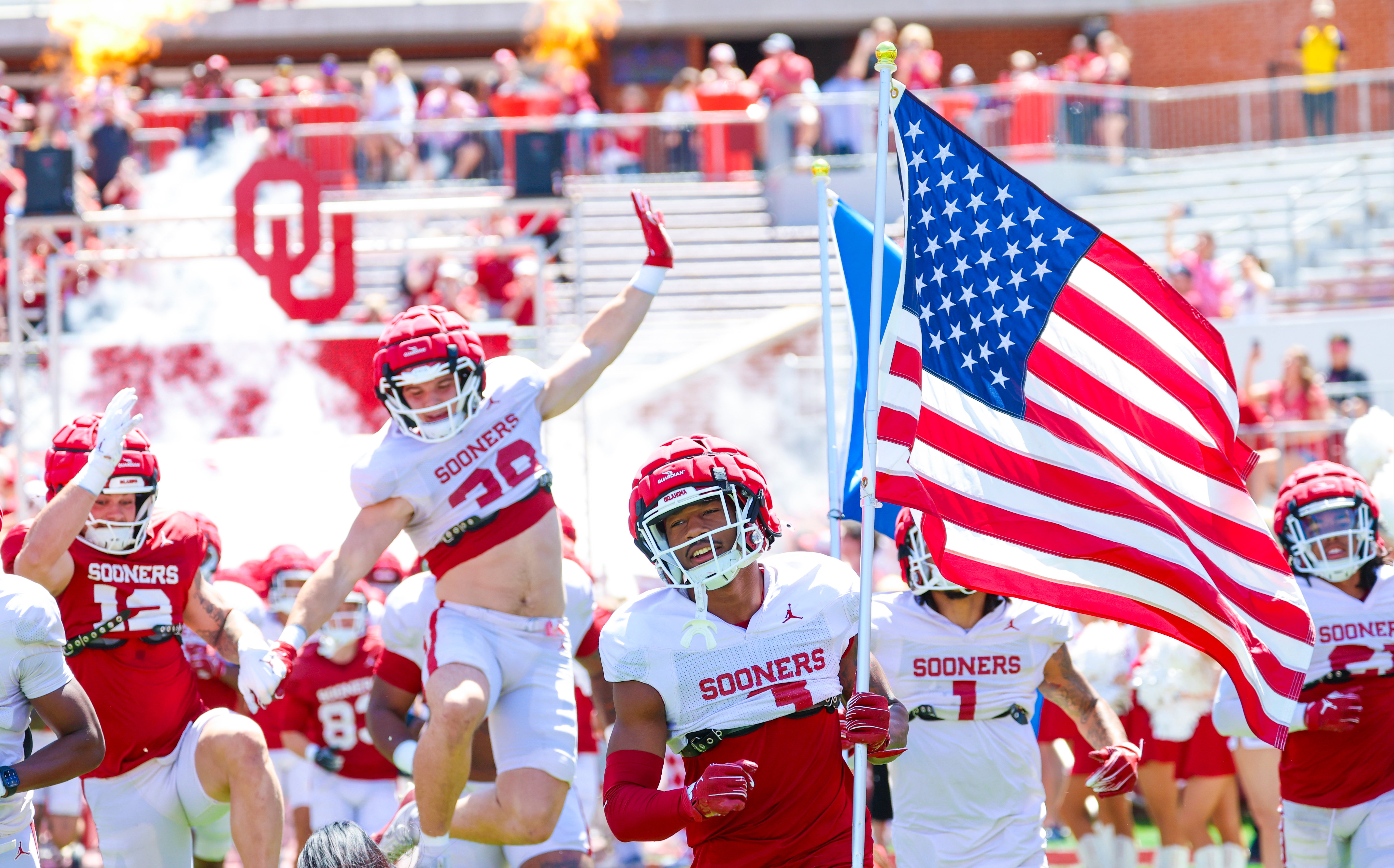 Apr 12, 2025; Norman, OK, USA; Oklahoma Sooners players enter the field during the Crimson Combine at Gaylord Family-Oklahoma Memorial Stadium.