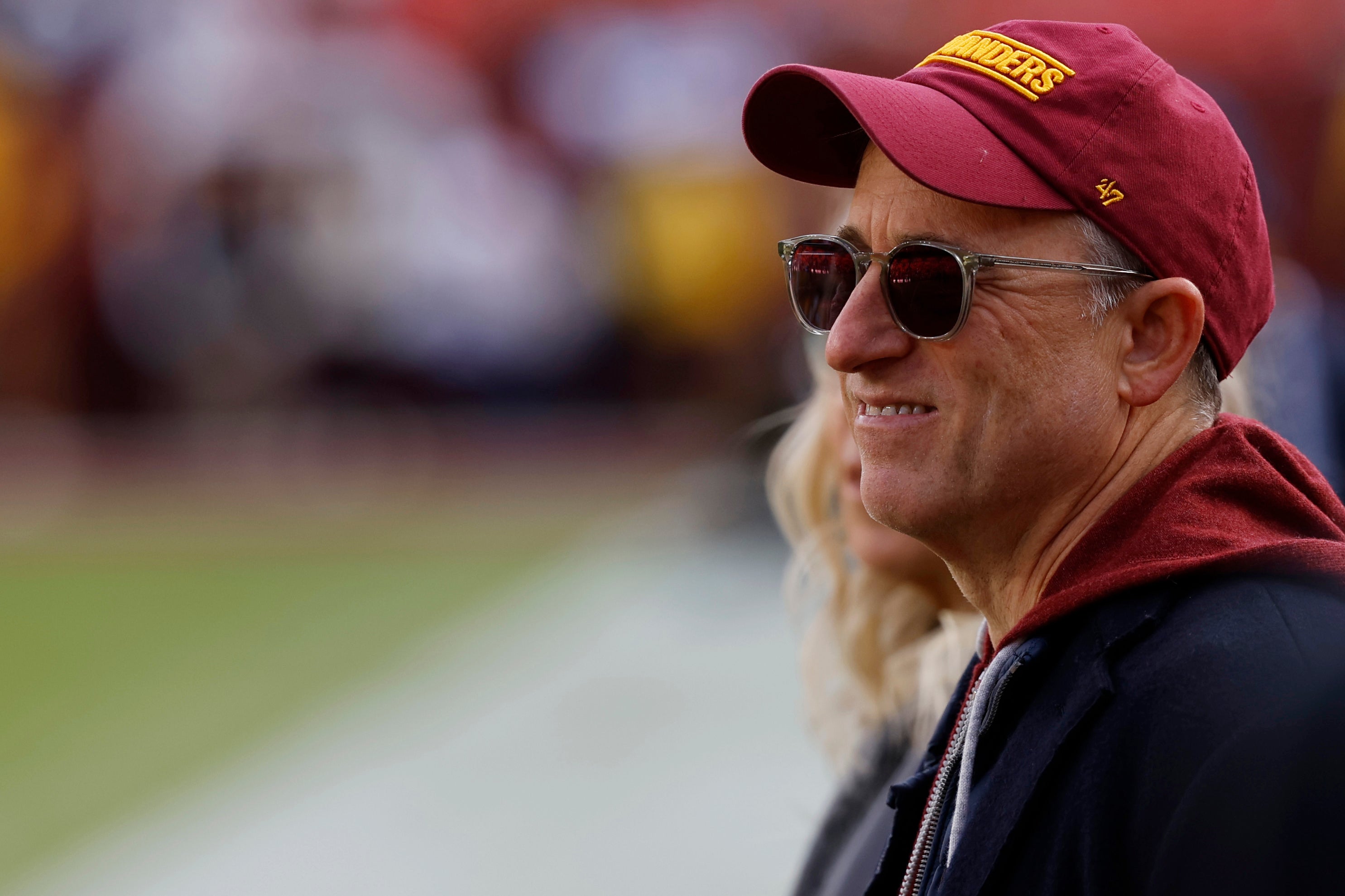 Washington Commanders owner Josh Harris stands on the field prior to the game against the Dallas Cowboys at Northwest Stadium.