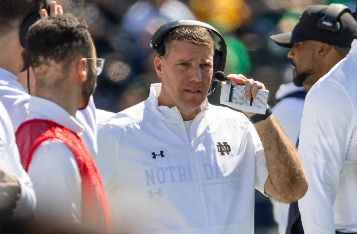 Apr 12, 2025; Notre Dame, IN, USA; Notre Dame defensive coordinator Chris Ash adjusts his headset during the Blue-Gold game at Notre Dame Stadium. Mandatory Credit: Michael Caterina-Imagn Images
