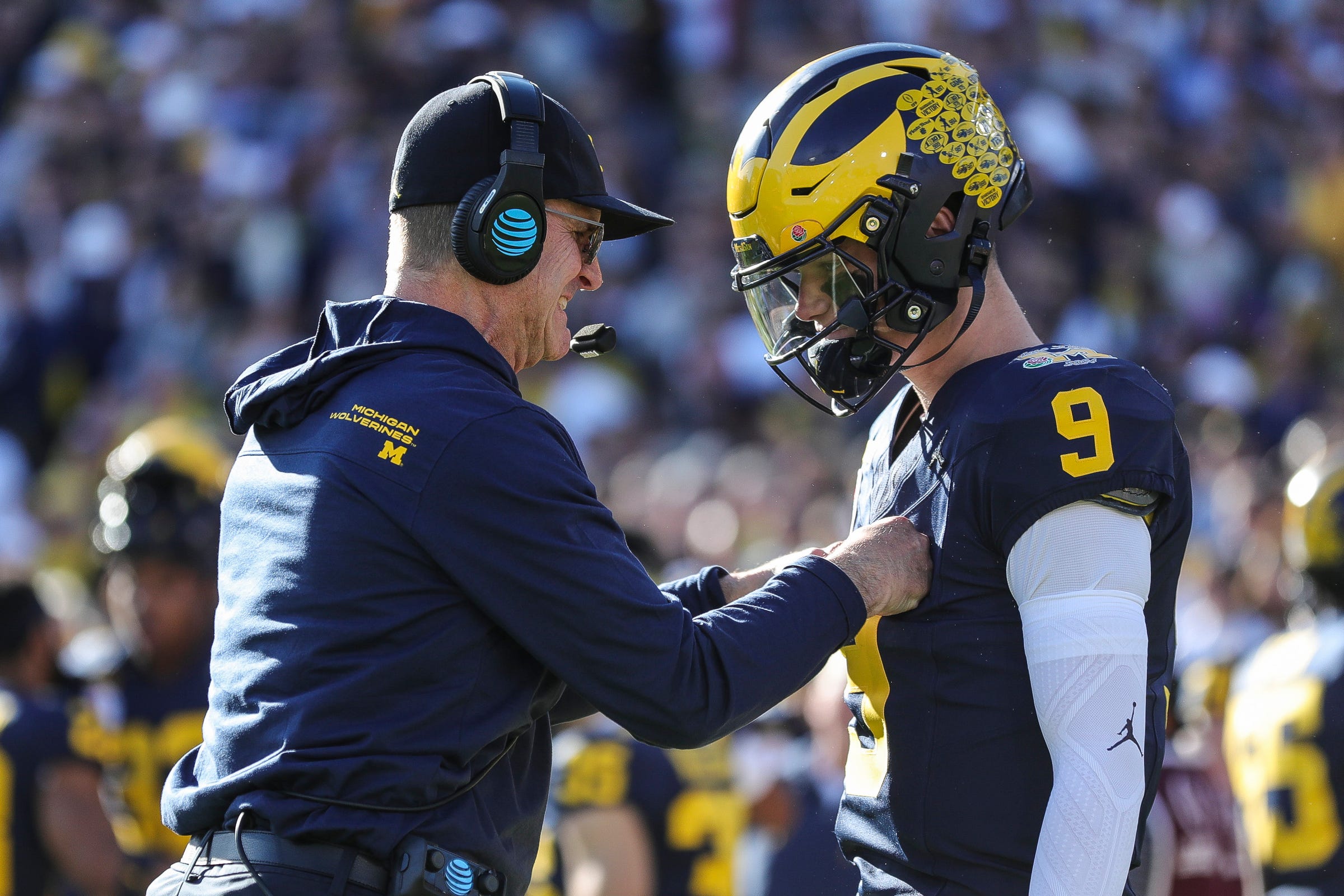 Michigan coach Jim Harbaugh talks to quarterback J.J. McCarthy before the start of the Rose Bowl vs. Alabama in Pasadena, California, on Monday, Jan. 1, 2024.