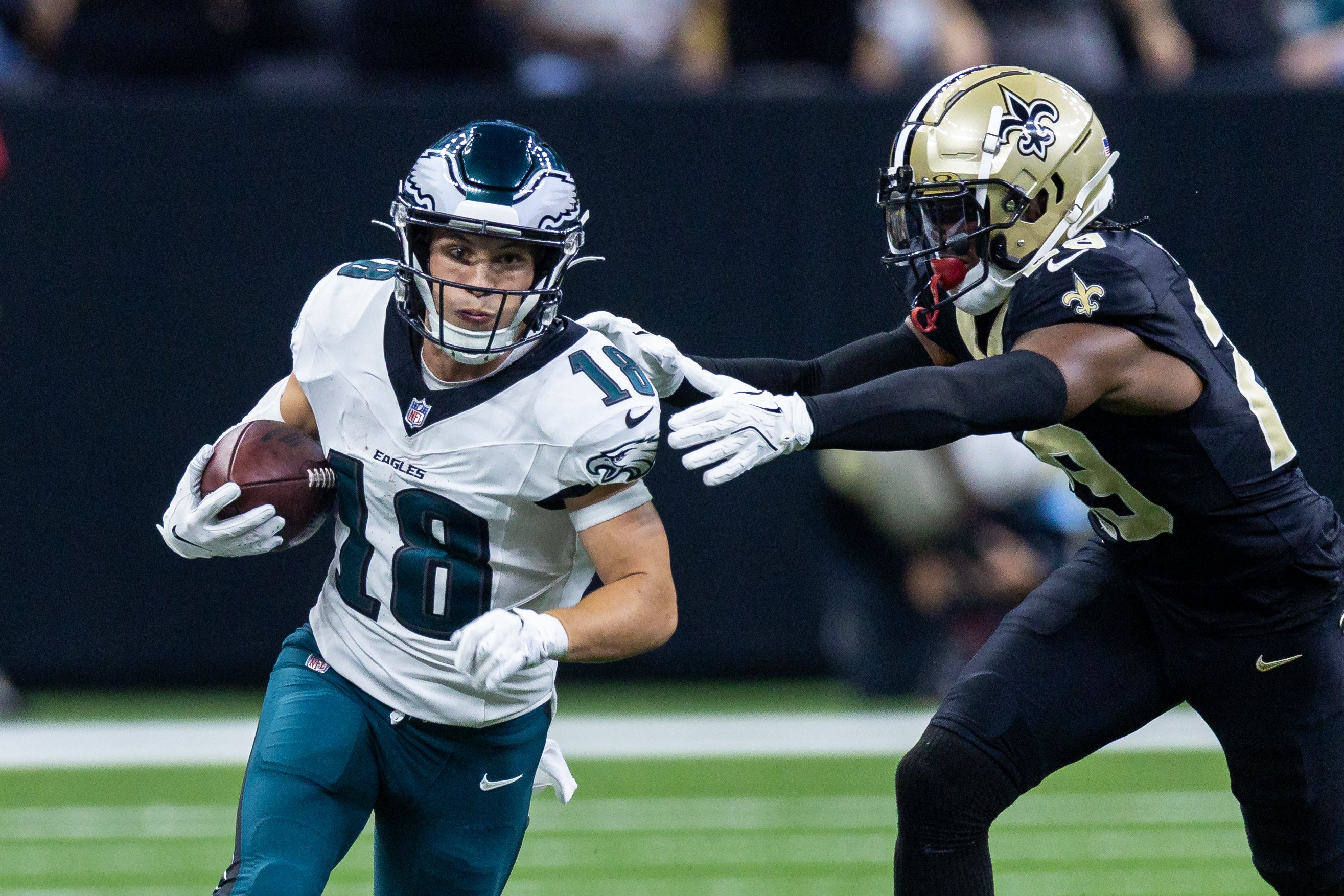 Philadelphia Eagles wide receiver Britain Covey (18) runs a pass back against New Orleans Saints cornerback Paulson Adebo (29) during the first half at Caesars Superdome.