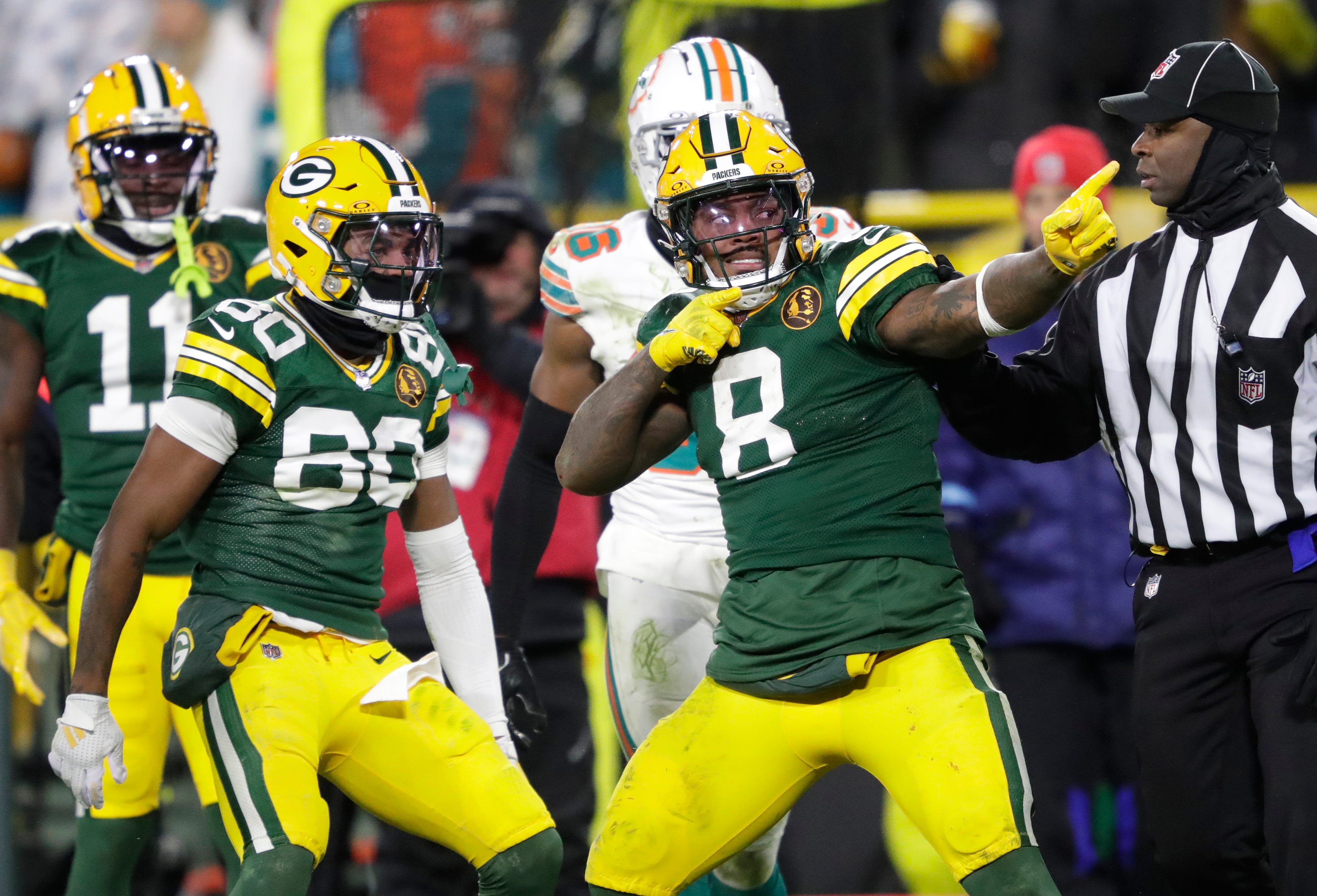 Green Bay Packers running back Josh Jacobs (8) celebrates after a long reception and run in the fourth quarter against the Miami Dolphins during their football game Thursday, November 28, 2024, at Lambeau Field in Green Bay, Wisconsin.