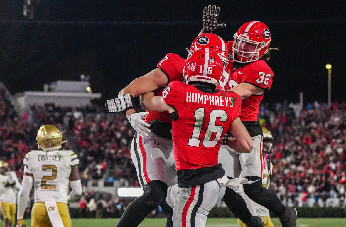 Nov 29, 2024; Athens, Georgia, USA; Georgia Bulldogs wide receiver London Humphreys (16) reacts with tight end Lawson Luckie (7) and running back Cash Jones (32) after scoring a touchdown against the Georgia Tech Yellow Jackets during overtime at Sanford Stadium. Mandatory Credit: Dale Zanine-Imagn Images
