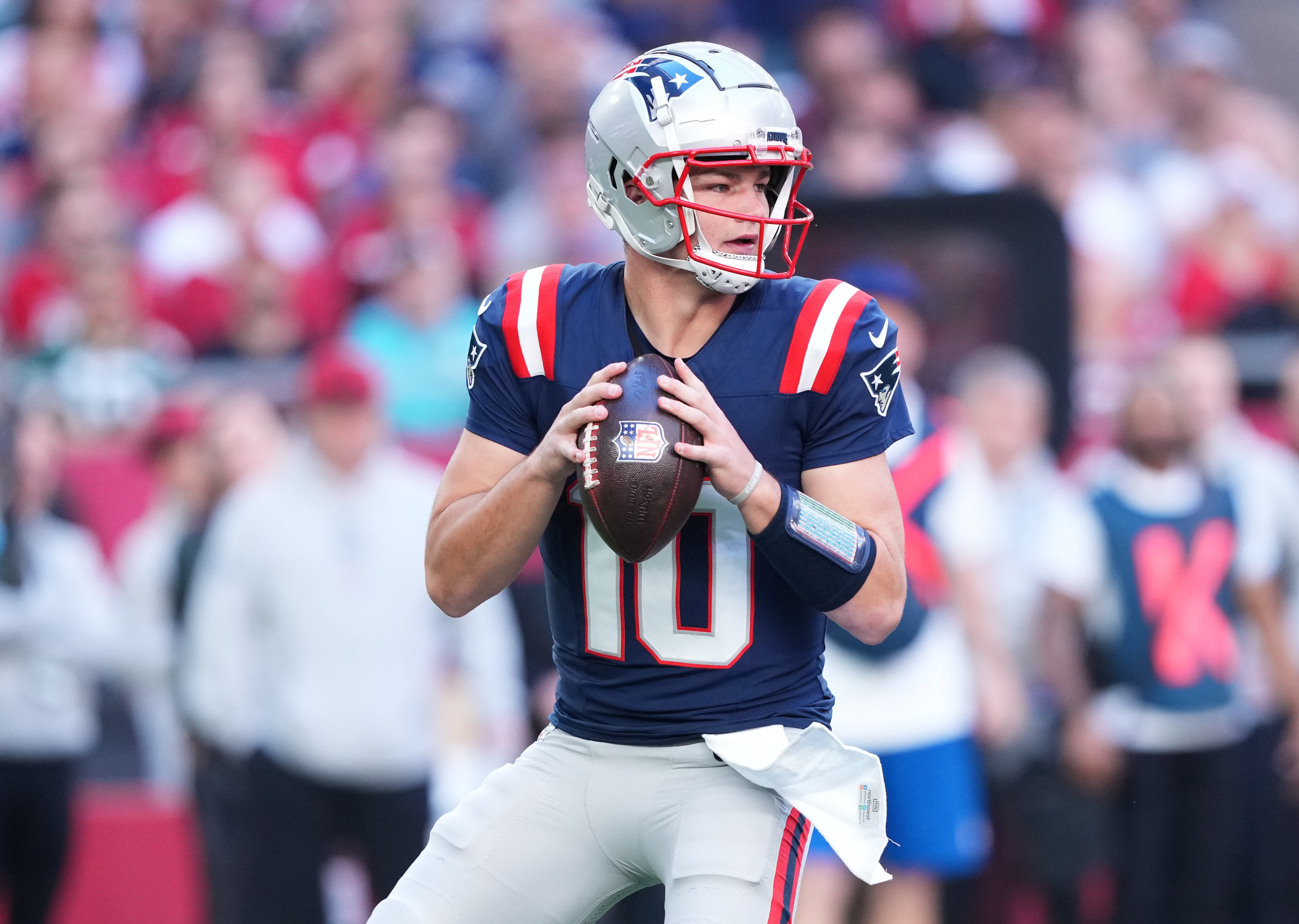 Dec 15, 2024; Glendale, Arizona, USA; New England Patriots quarterback Drake Maye (10) passes against the Arizona Cardinals during the first half at State Farm Stadium.