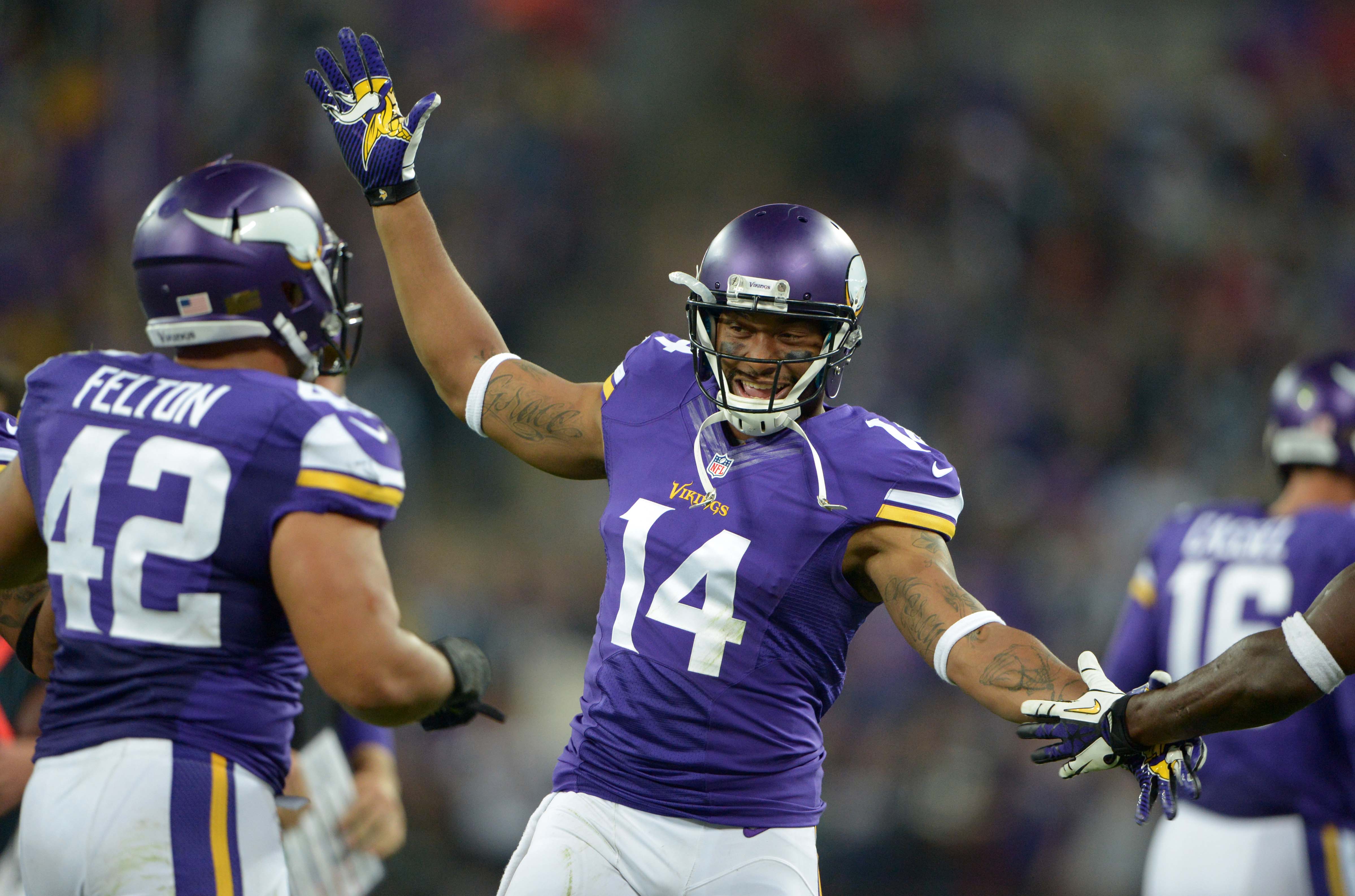 Sep 29, 2013; London, UNITED KINGDOM; Minnesota Vikings receiver Joe Webb (14) celebrates with fullback Jerome Felton (42) in the final minute in the NFL International Series game against the Pittsburgh Steelers at Wembley Stadium. The Vikings defeated the Steelers 34-27.