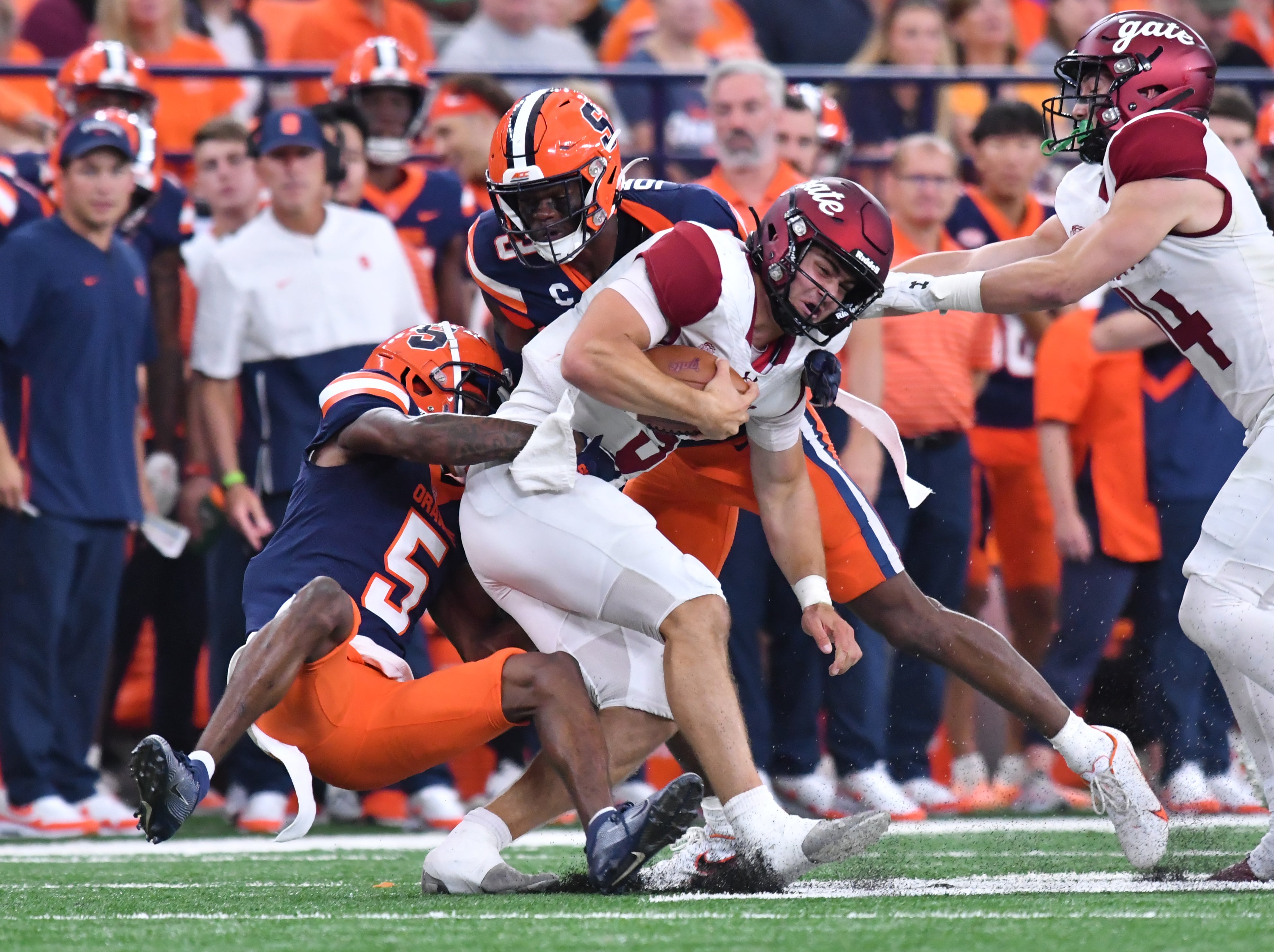 Colgate Raiders quarterback Michael Brescia is tackled by Syracuse Orange defensive back Alijah Clark (5) in the second quarter at the JMA Wireless Dome.