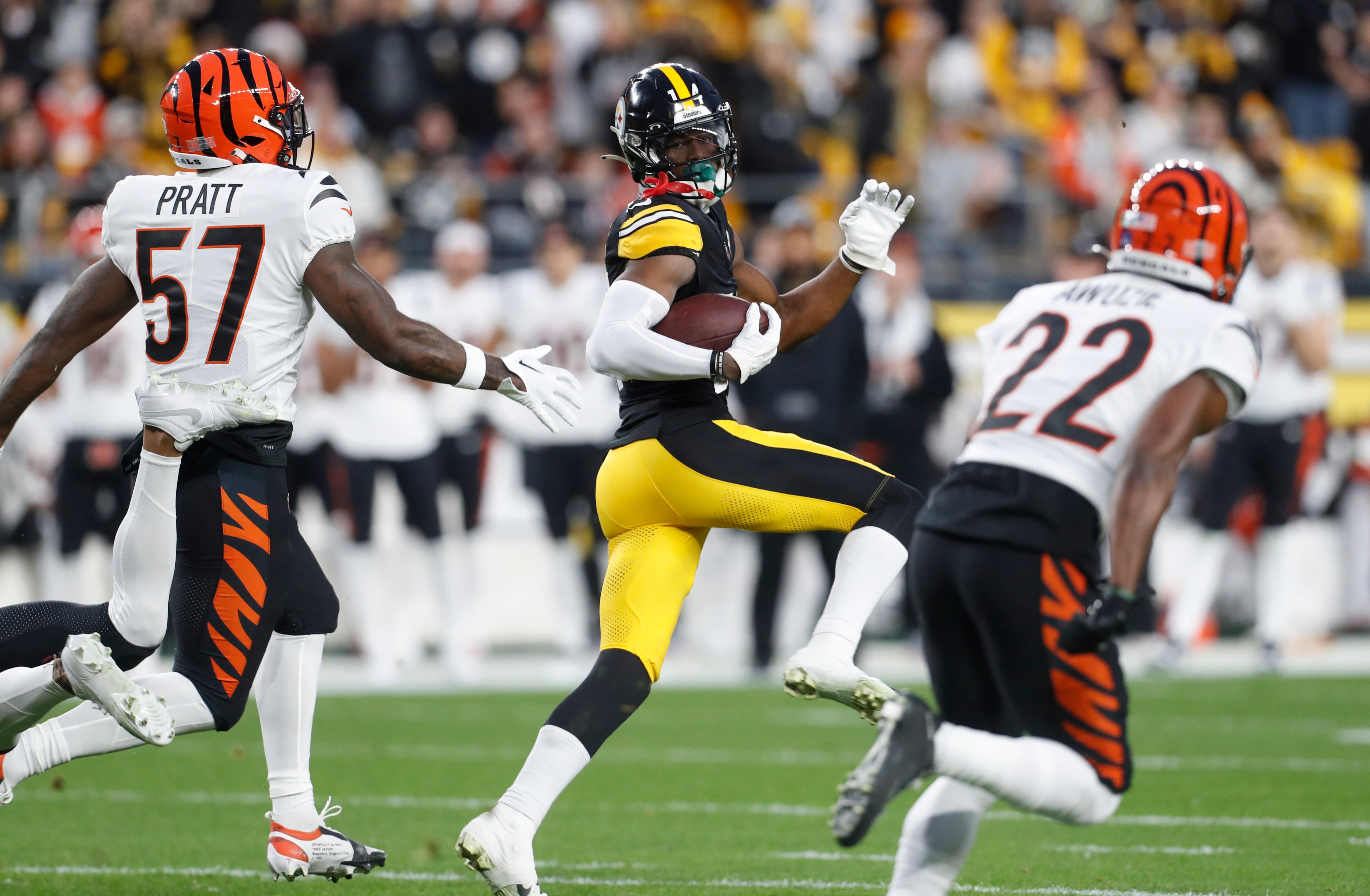 Dec 23, 2023; Pittsburgh, Pennsylvania, USA; Pittsburgh Steelers wide receiver George Pickens (14) runs on an eight-six yard touchdown reception as Cincinnati Bengals linebacker Germaine Pratt (57) and cornerback Chidobe Awuzie (22) chase during the first quarter at Acrisure Stadium.