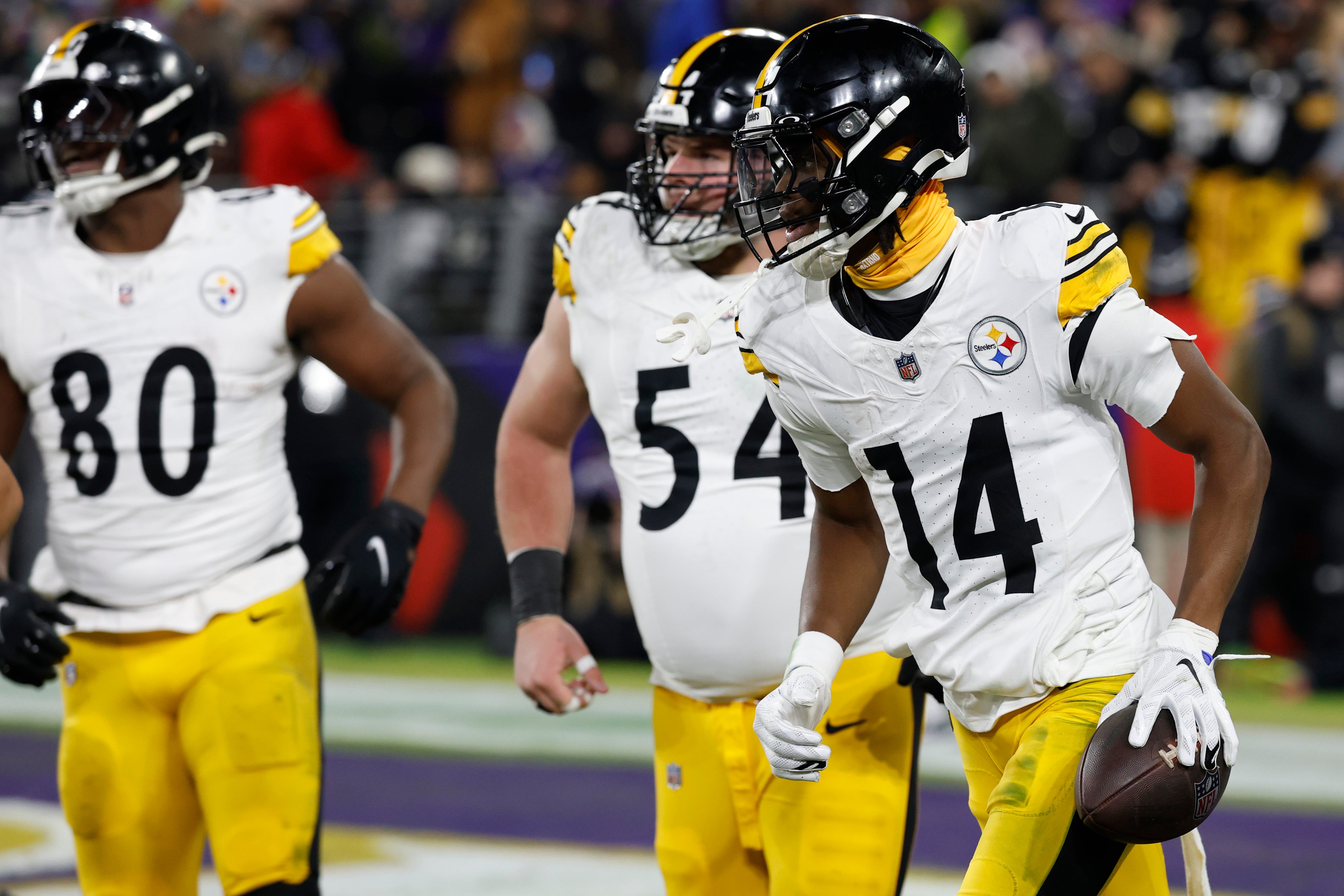 Pittsburgh Steelers wide receiver George Pickens (14) reacts after catching a touchdown pass against the Baltimore Ravens in an AFC wild card game at M&T Bank Stadium.