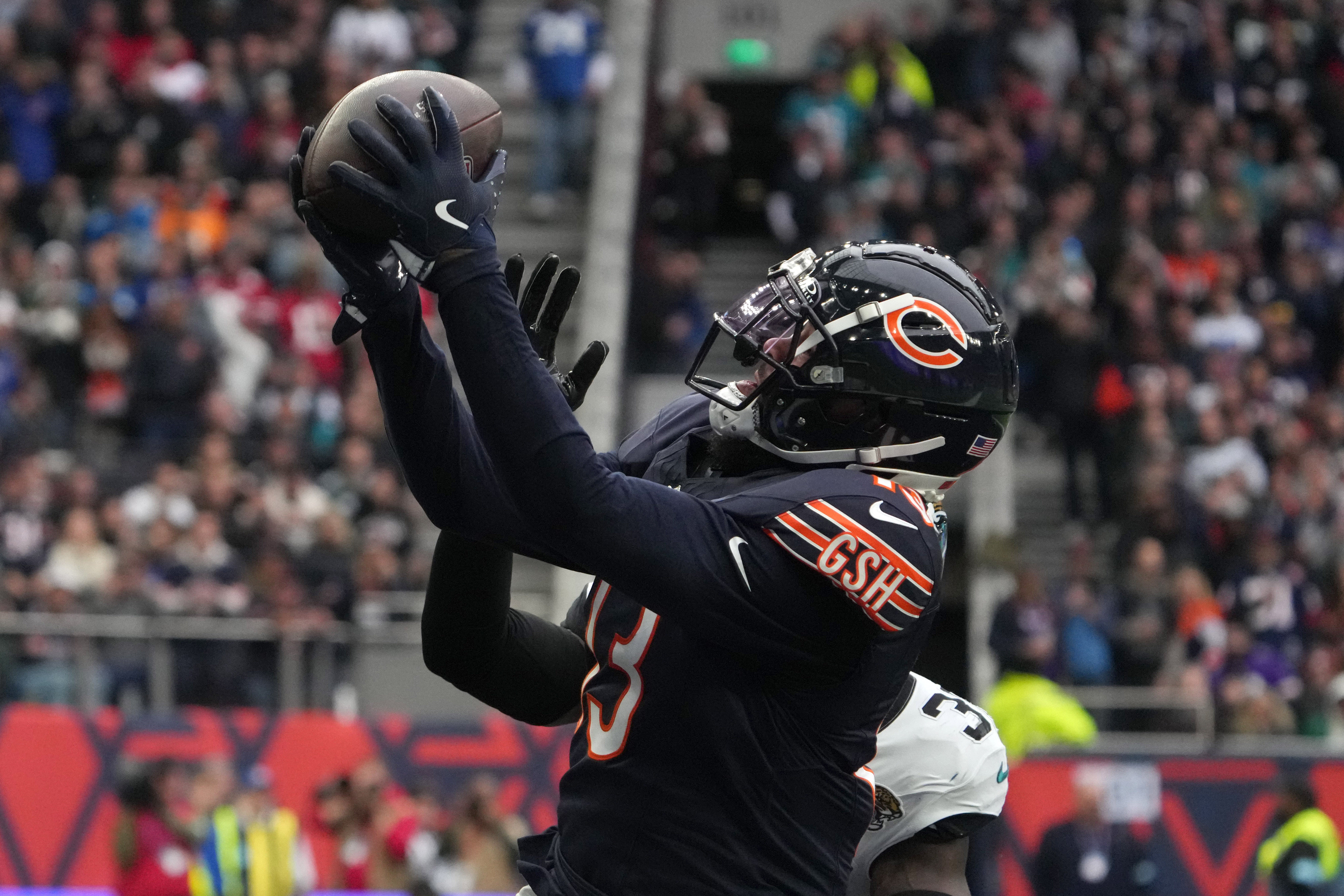 Chicago Bears wide receiver Keenan Allen (13) catches a three-yard touchdown pass against Jacksonville Jaguars cornerback Montaric Brown (30) in the second half during an NFL International Series game at Tottenham Hotspur Stadium.