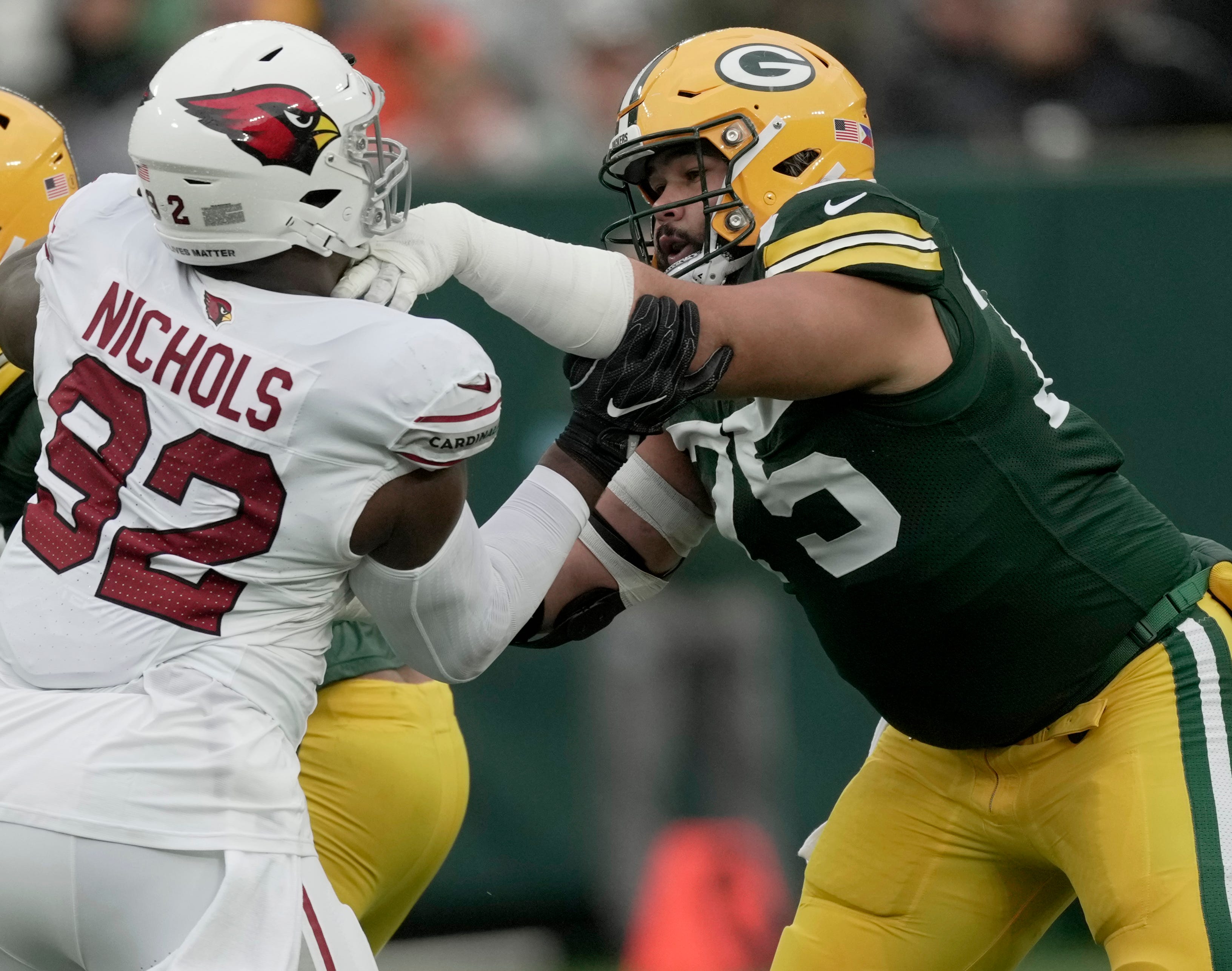 Green Bay Packers guard Sean Rhyan (75) blocks Arizona Cardinals defensive tackle Bilal Nichols (92) during the first quarter of their game Sunday, October 13, 2024 at Lambeau Field in Green Bay, Wisconsin.