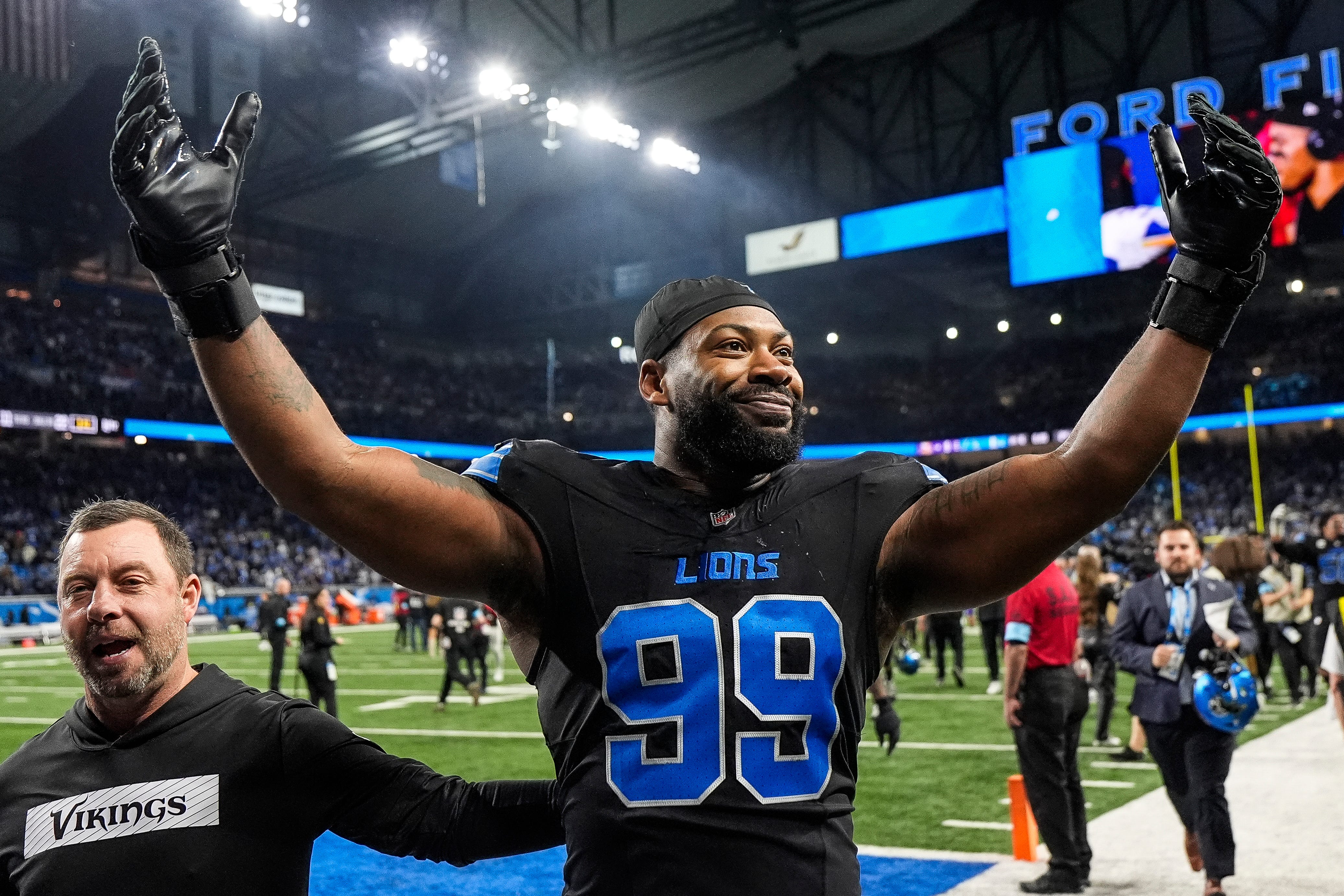 Detroit Lions defensive end Za'Darius Smith (99) celebrates 31-9 win over Minnesota Vikings as he exits the field at Ford Field in Detroit on Sunday, Jan. 5, 2025.