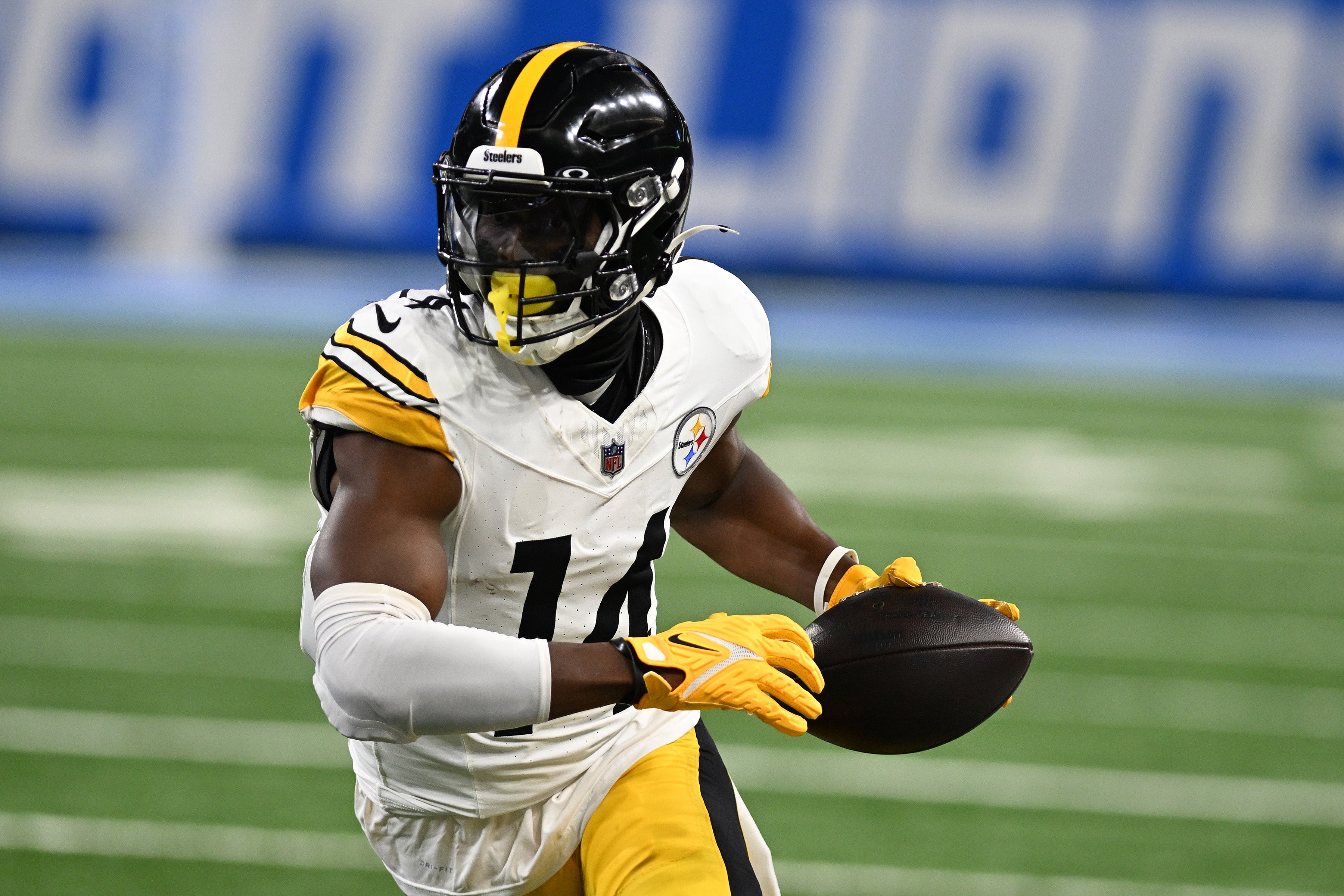 Pittsburgh Steelers wide receiver George Pickens (14) runs upfield after catching a pass against the Detroit Lions in the first quarter at Ford Field.