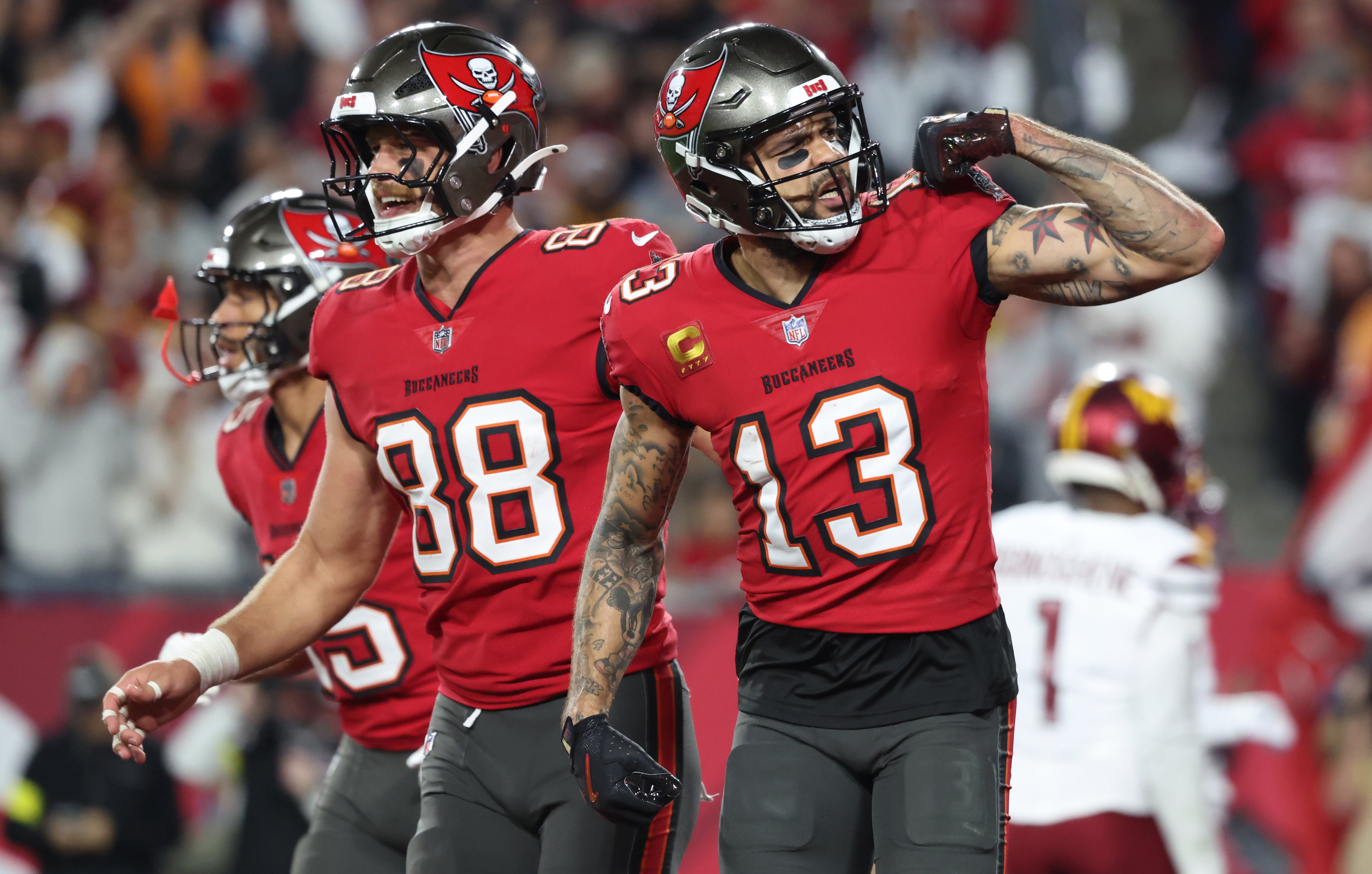 Jan 12, 2025; Tampa, Florida, USA; Tampa Bay Buccaneers wide receiver Mike Evans (13) celebrates after a touchdown catch with tight end Cade Otton (88) during the second quarter of a NFC wild card playoff against the Washington Commanders at Raymond James Stadium.