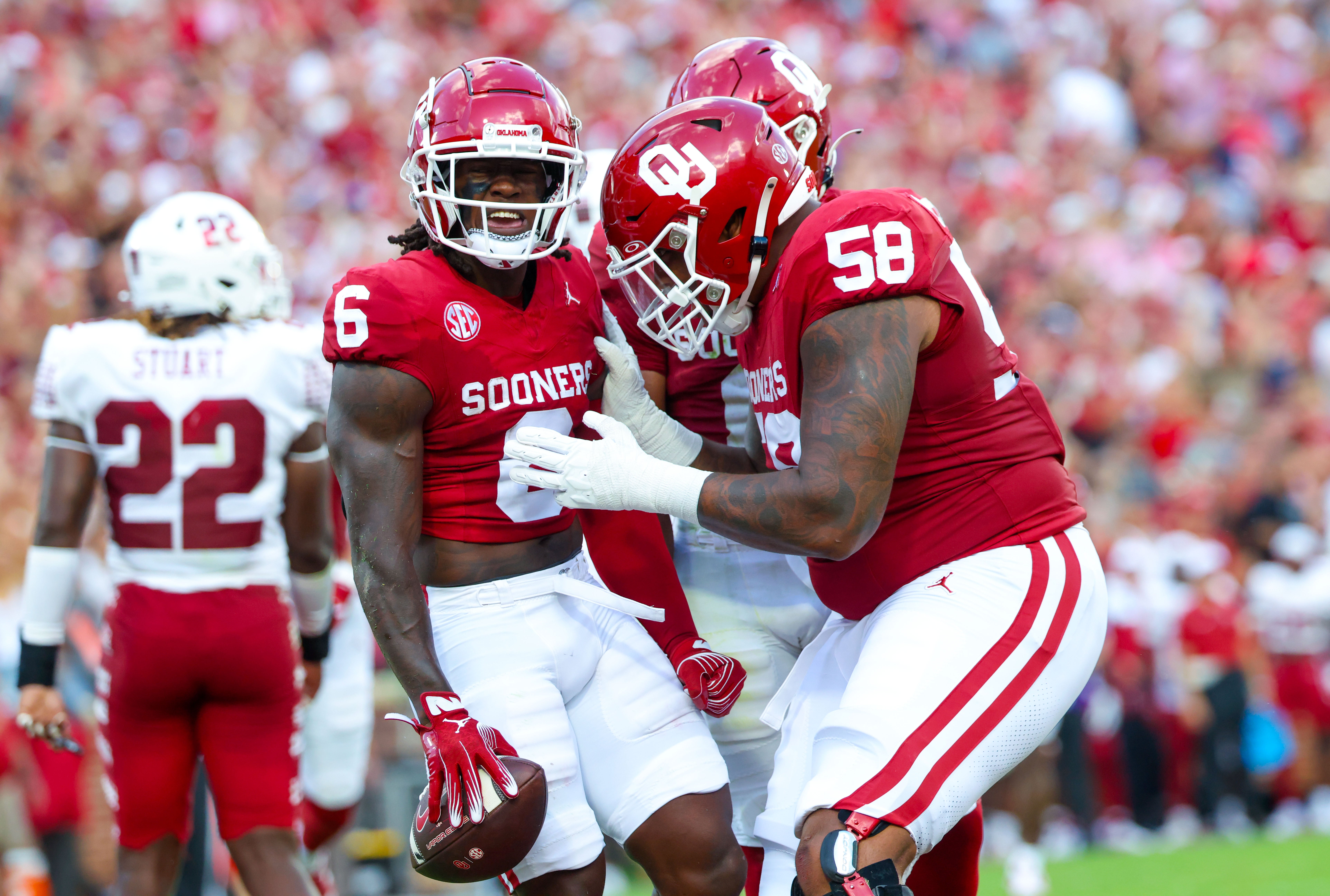 Aug 30, 2024; Norman, Oklahoma, USA; Oklahoma Sooners wide receiver Deion Burks (6) celebrates with Oklahoma Sooners offensive lineman Spencer Brown (58) after scoring during the first quarter against the Temple Owls at Gaylord Family-Oklahoma Memorial Stadium.