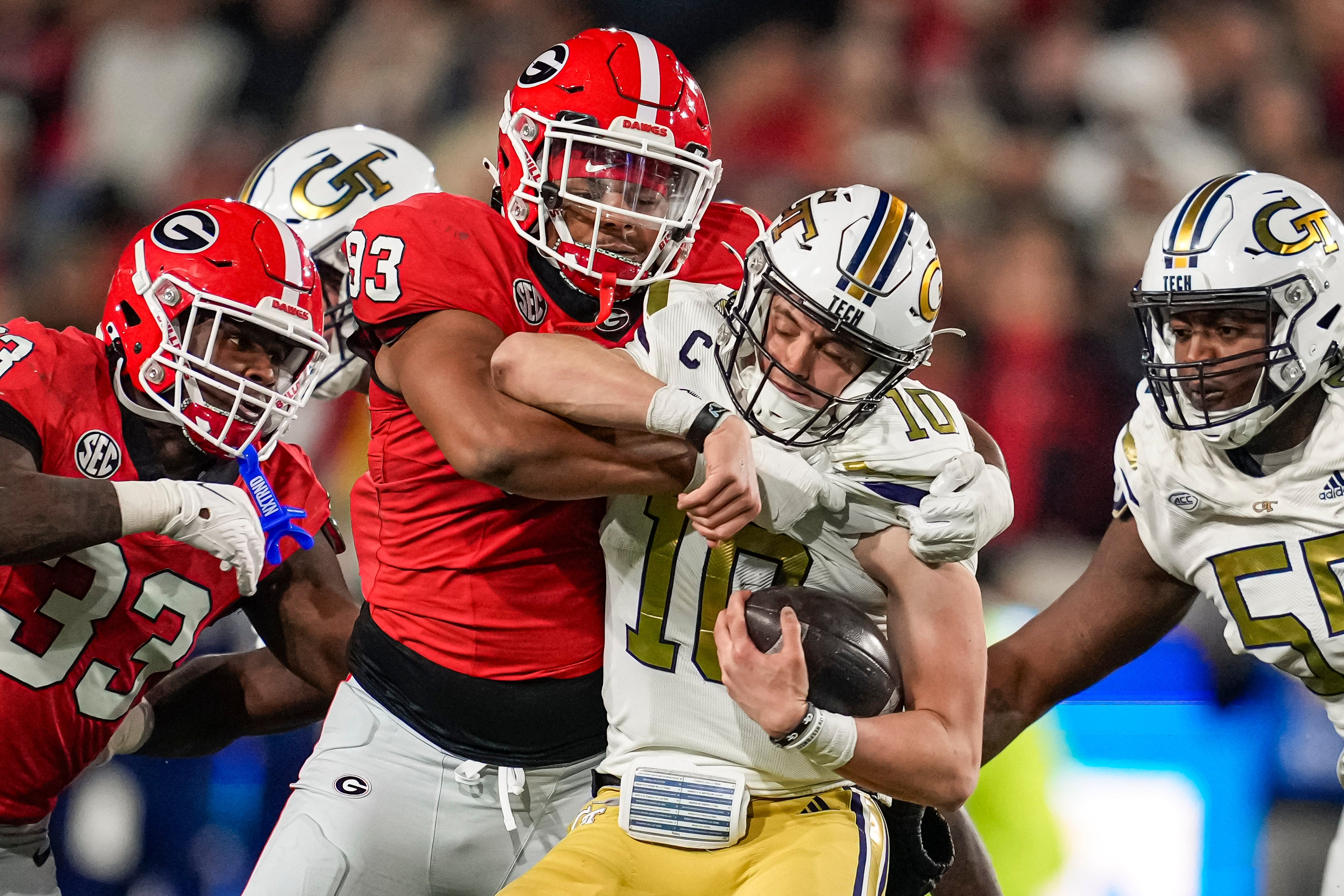 Nov 25, 2023; Atlanta, Georgia, USA; Georgia Bulldogs defensive lineman Tyrion Ingram-Dawkins (93) tackles Georgia Tech Yellow Jackets quarterback Haynes King (10) during the second half at Hyundai Field.