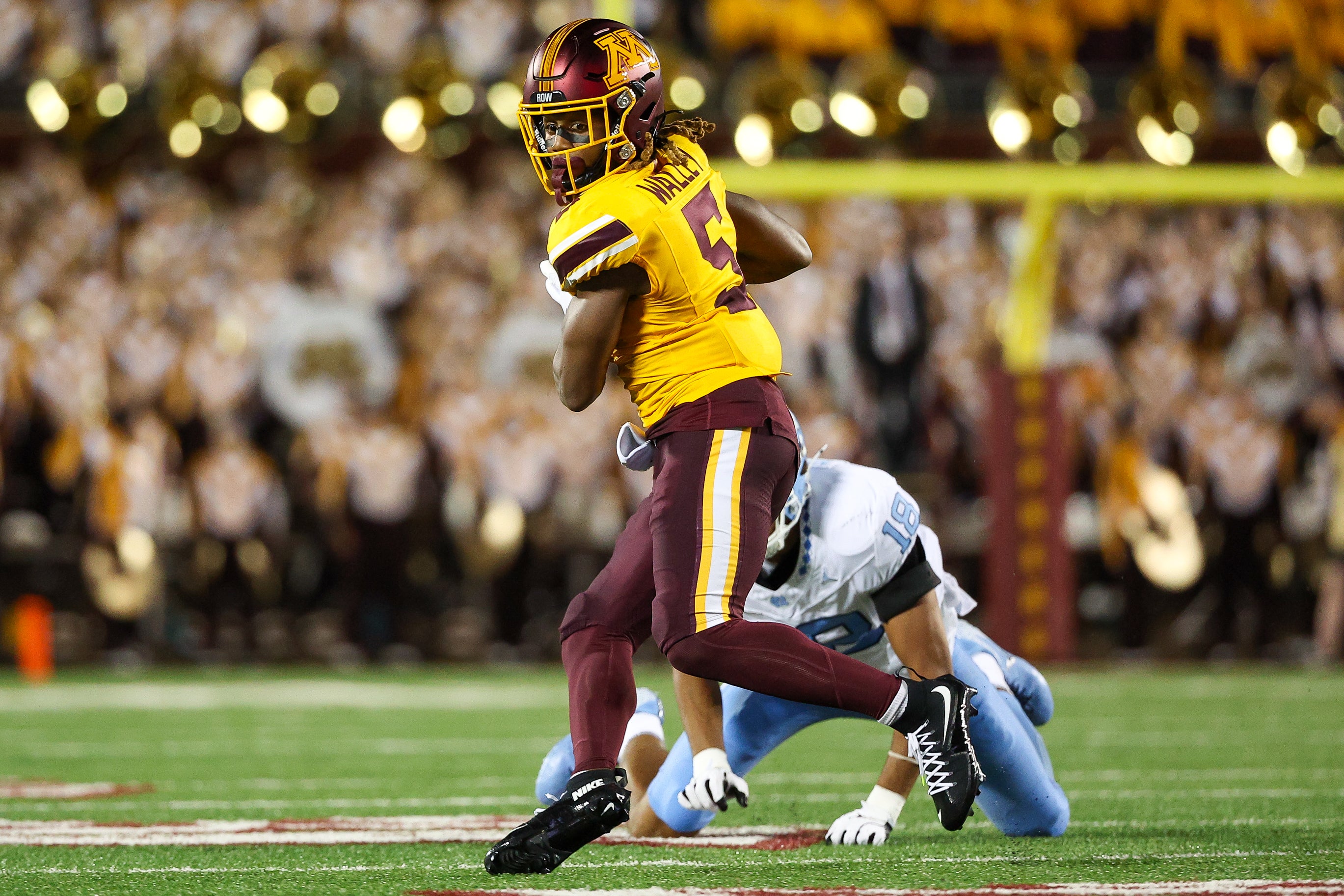 Aug 29, 2024; Minneapolis, Minnesota, USA; Minnesota Golden Gophers defensive back Justin Walley (5) intercepts a pass intended for North Carolina Tar Heels tight end Bryson Nesbit (18) during the first half at Huntington Bank Stadium.