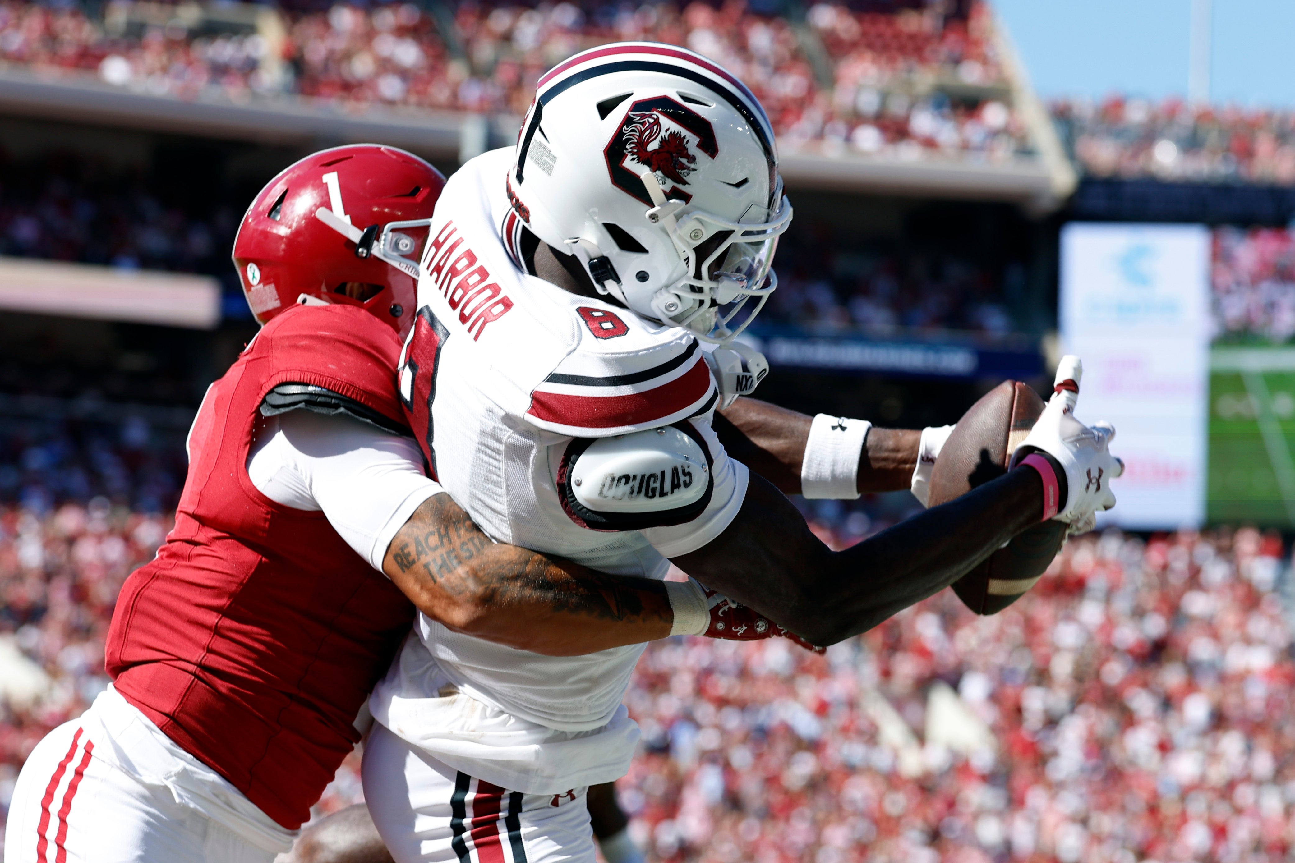 Oct 12, 2024; Tuscaloosa, Alabama, USA; South Carolina Gamecocks wide receiver Nyck Harbor (8) catches a pass for a touchdown as Alabama Crimson Tide defensive back Domani Jackson (1) defends during the second half at Bryant-Denny Stadium. Mandatory Credit: Butch Dill-Imagn Images