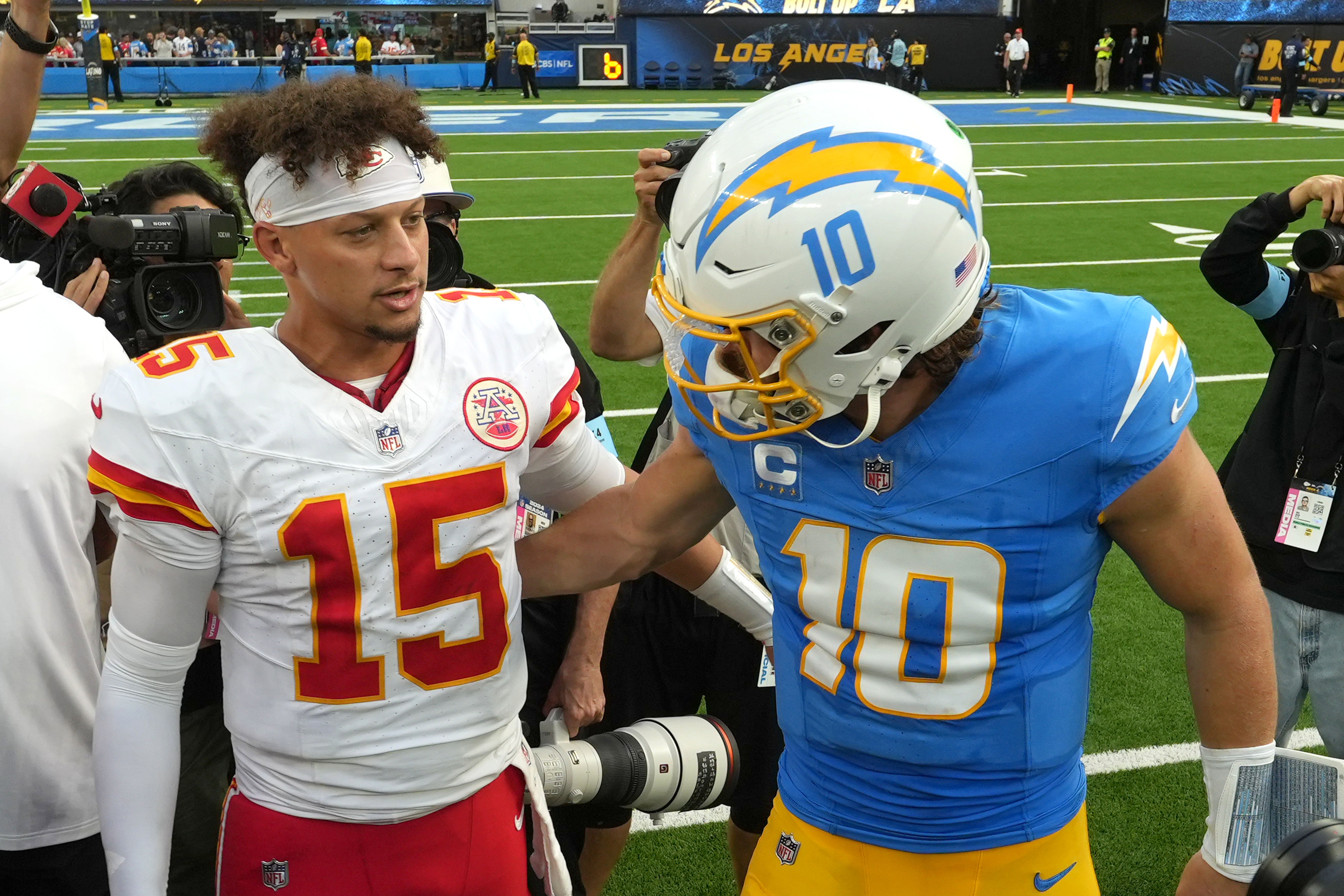 Sep 29, 2024; Inglewood, California, USA; Kansas City Chiefs quarterback Patrick Mahomes (15) and Los Angeles Chargers quarterback Justin Herbert (10) shake hands after the game at SoFi Stadium.