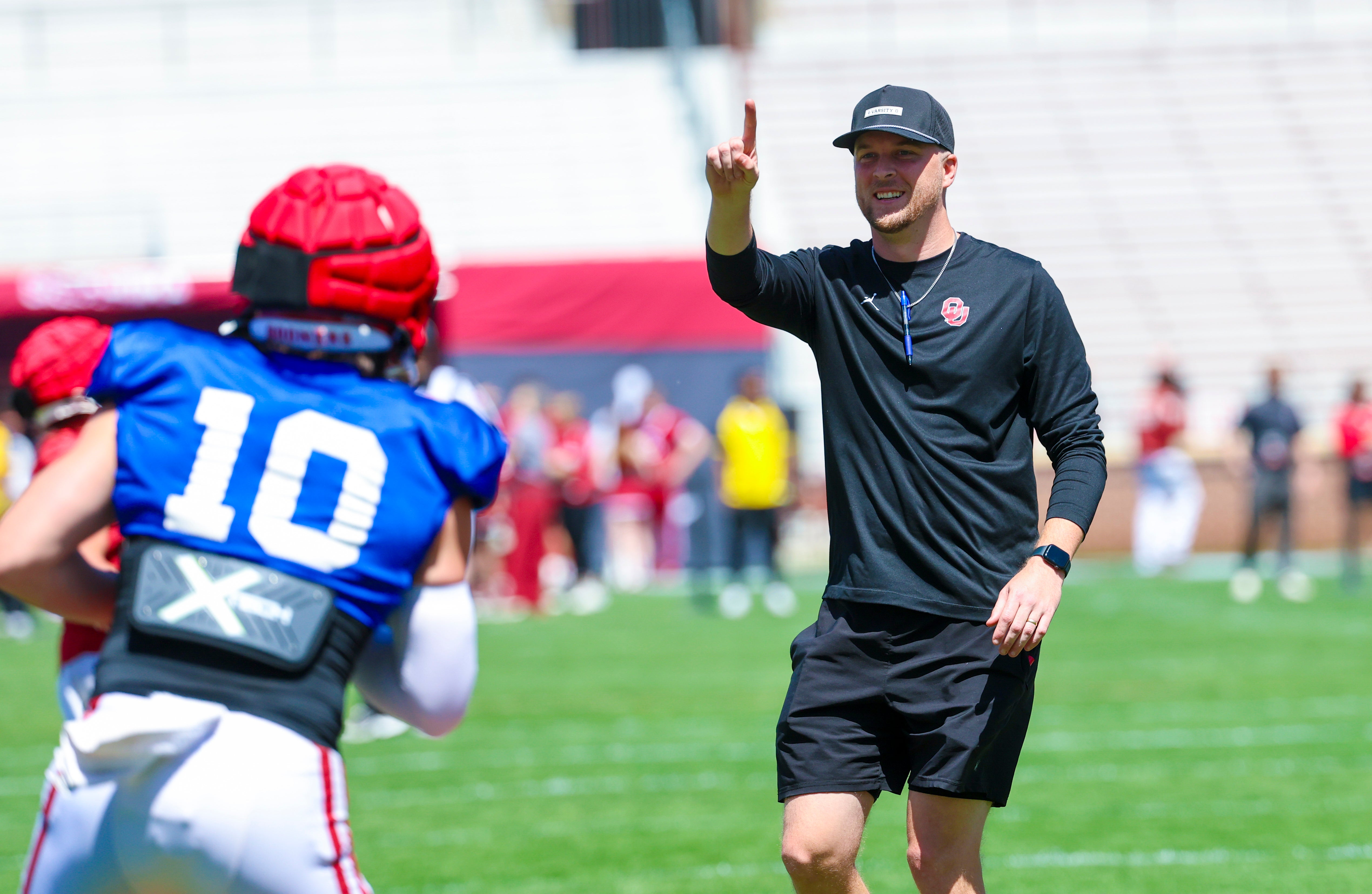 Apr 12, 2025; Norman, OK, USA; Oklahoma Sooners offensive coordinator Ben Arbuckle coaches quarterback John Mateer (10) during the Crimson Combine at Gaylord Family-Oklahoma Memorial Stadium.