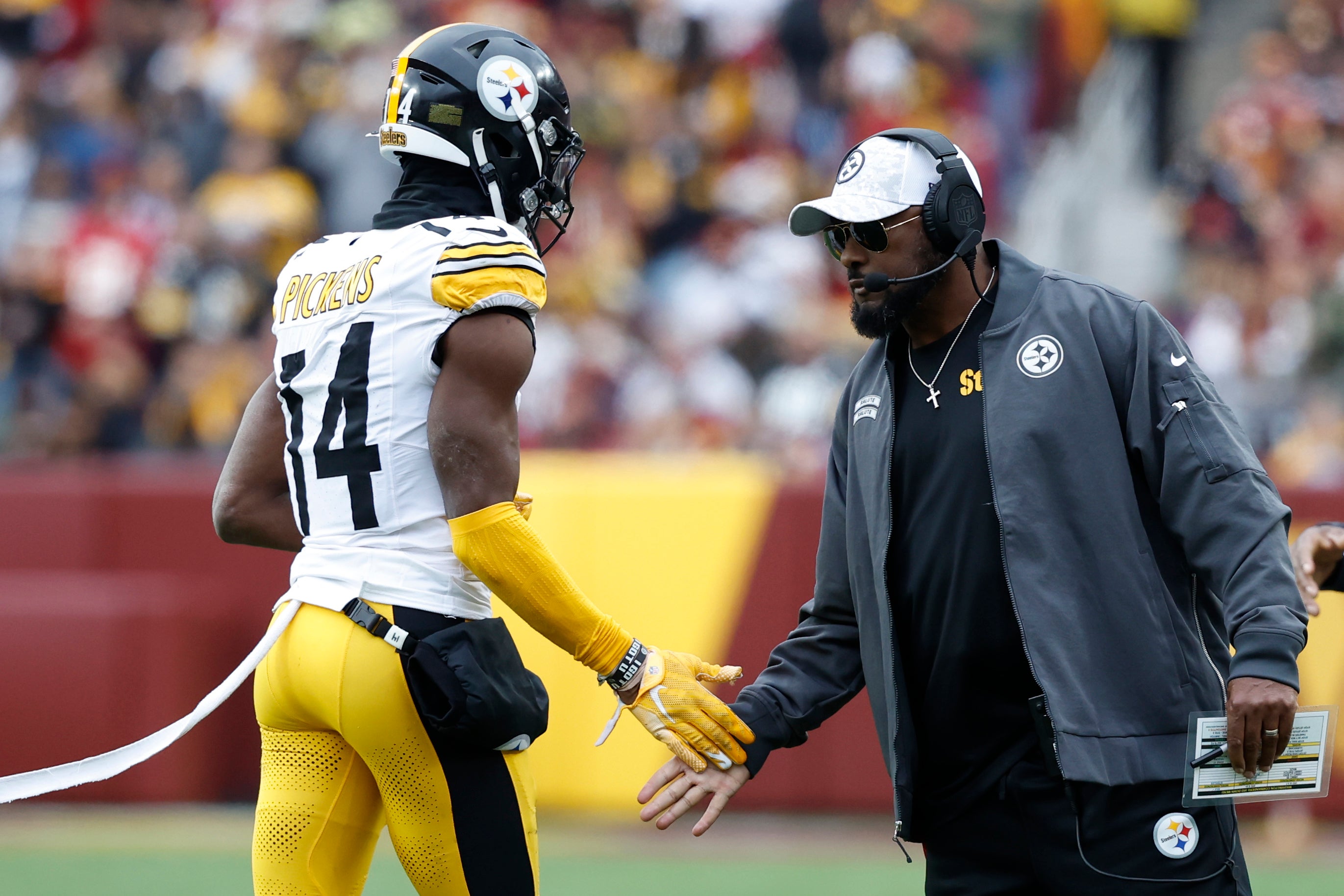Pittsburgh Steelers head coach Mike Tomlin (R) congratulates Steelers wide receiver George Pickens (14) after a long catch against the Washington Commanders during the second half at Northwest Stadium.
