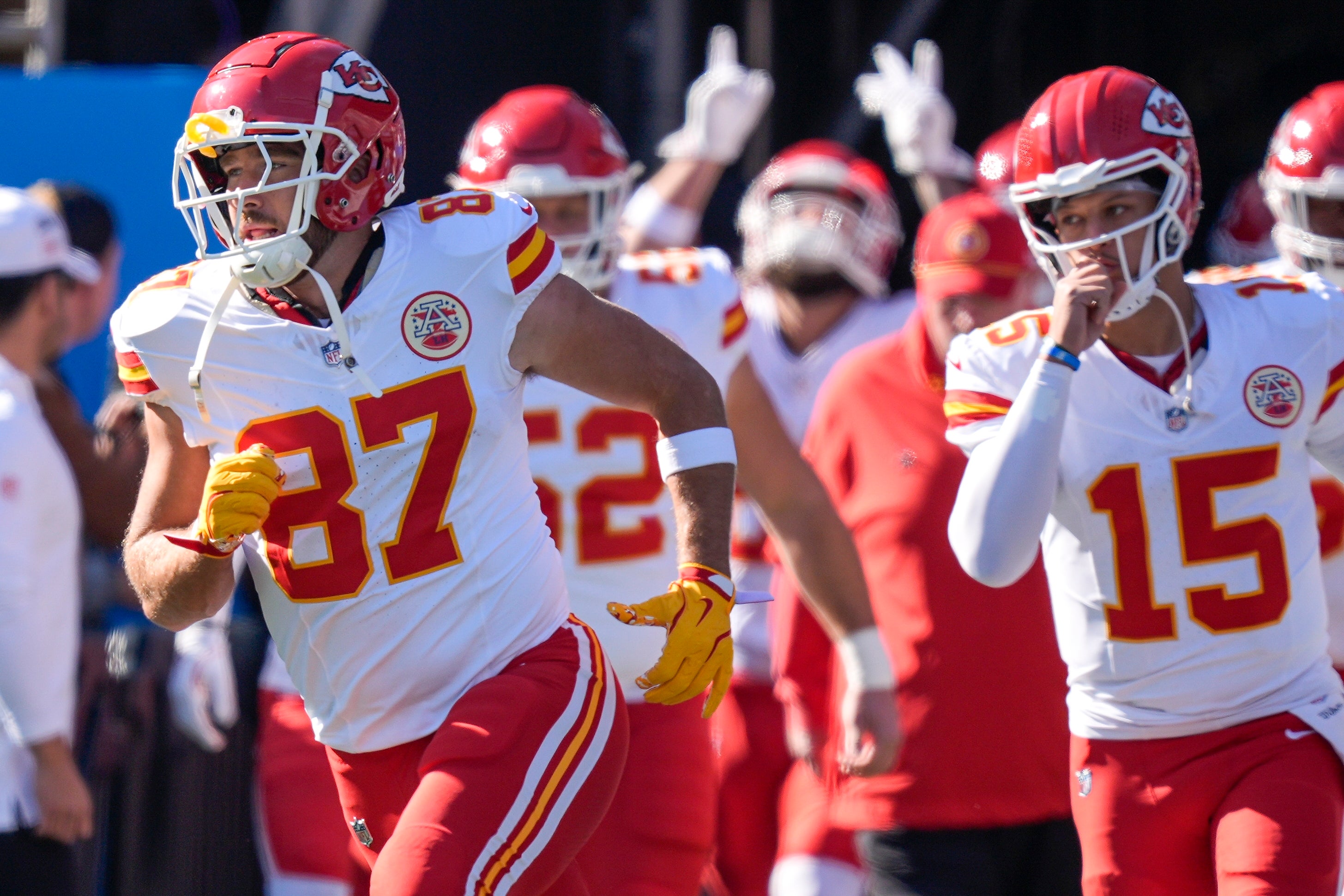 Nov 24, 2024; Charlotte, North Carolina, USA; Kansas City Chiefs tight end Travis Kelce (87) and quarterback Patrick Mahomes (15) lead their team onto the field against the Carolina Panthers during the first quarter at Bank of America Stadium.