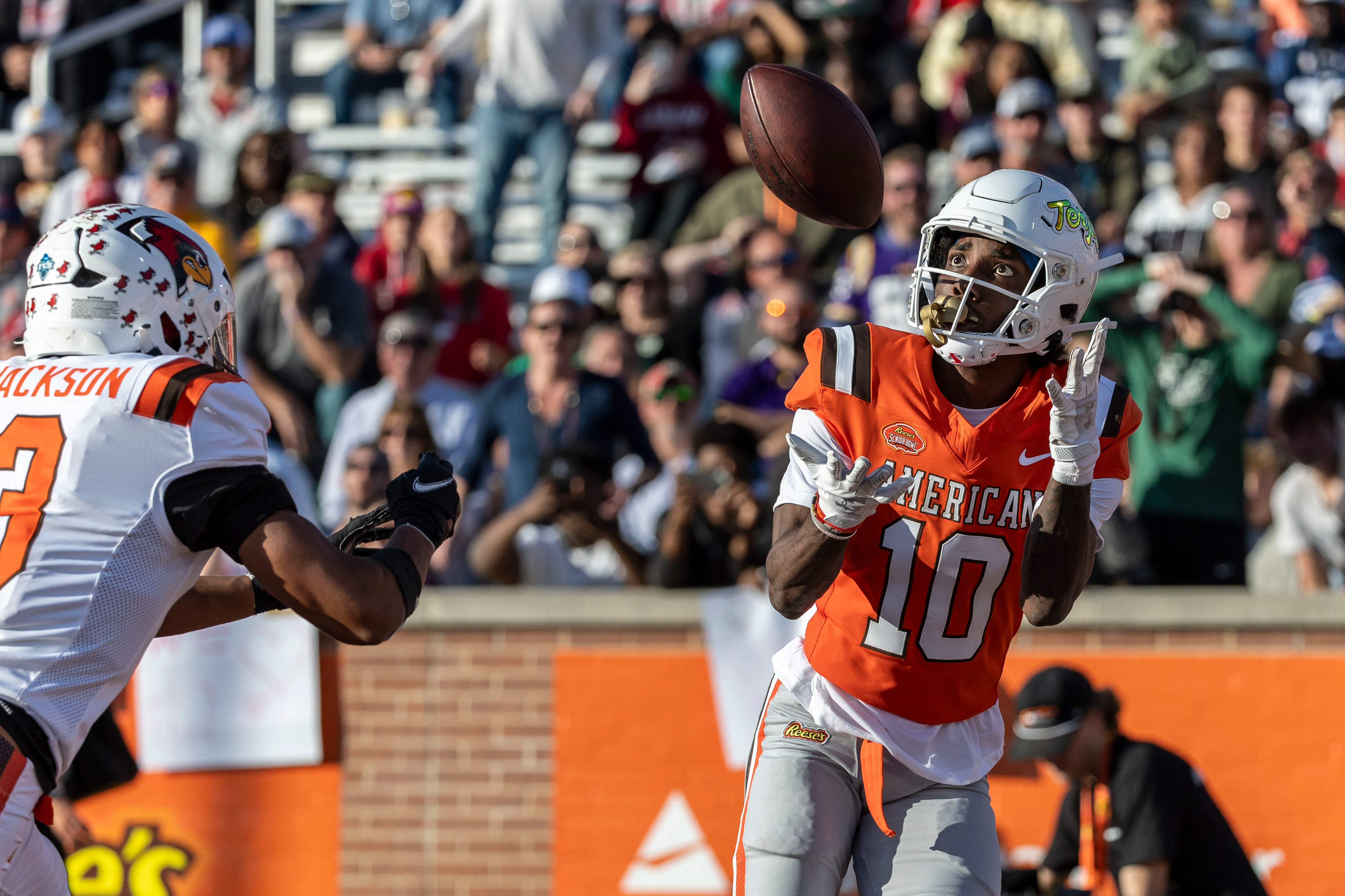 Feb 1, 2025; Mobile, AL, USA; American team wide receiver Tai Felton of Maryland (10) grabs a touchdown pass against the National team during the second half of the 2025 Senior Bowl at Hancock Whitney Stadium.