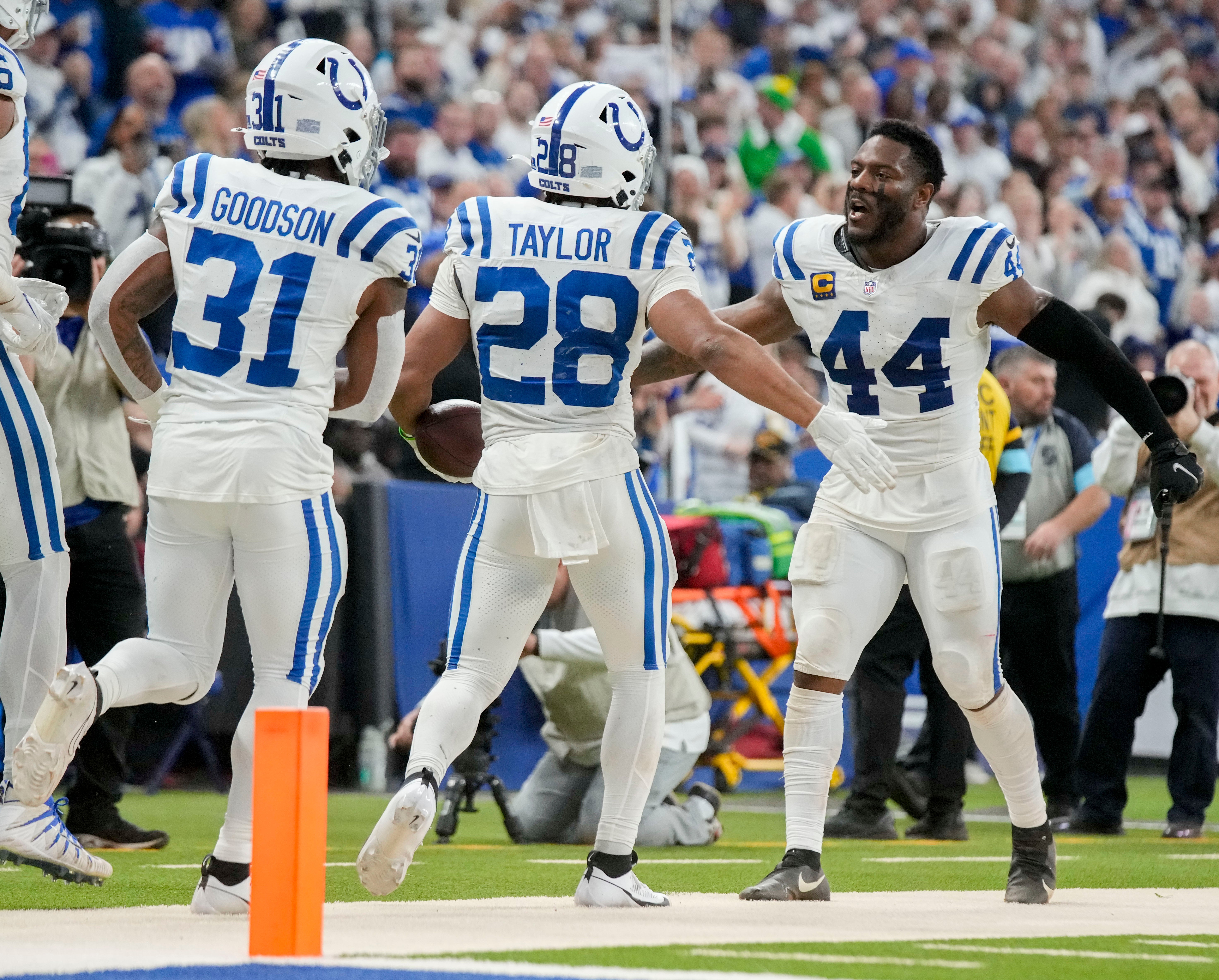 Dec 22, 2024; Indianapolis, Indiana, USA; Indianapolis Colts running back Jonathan Taylor (28) celebrates with Indianapolis Colts running back Tyler Goodson (31) and Indianapolis Colts linebacker Zaire Franklin (44) after rushing for a touchdown during a game against the Tennessee Titans at Lucas Oil Stadium.