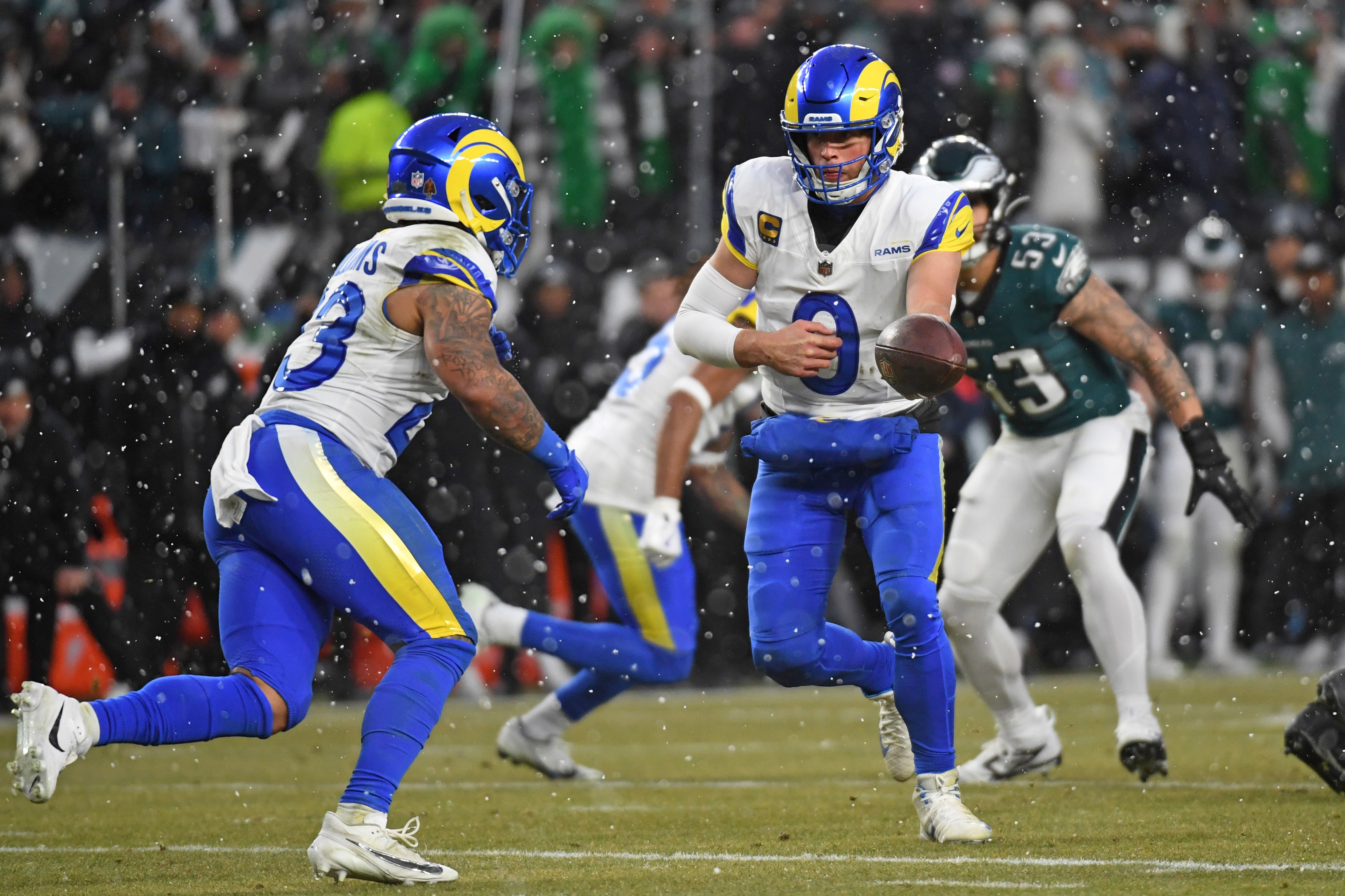 Los Angeles Rams quarterback Matthew Stafford (9) hands the ball off to running back Kyren Williams (23) against the Philadelphia Eagles in a 2025 NFC divisional round game at Lincoln Financial Field.