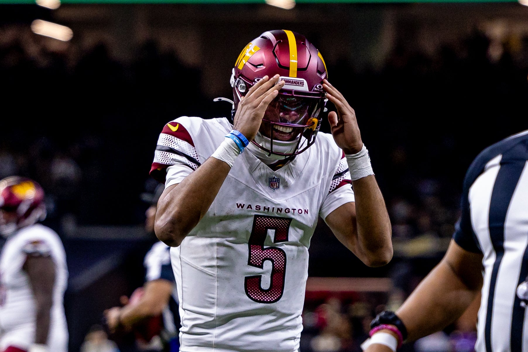 Dec 15, 2024; New Orleans, Louisiana, USA; Washington Commanders quarterback Jayden Daniels (5) reacts to throwing a touchdown to wide receiver Terry McLaurin (17) against the New Orleans Saints during the first half at Caesars Superdome.