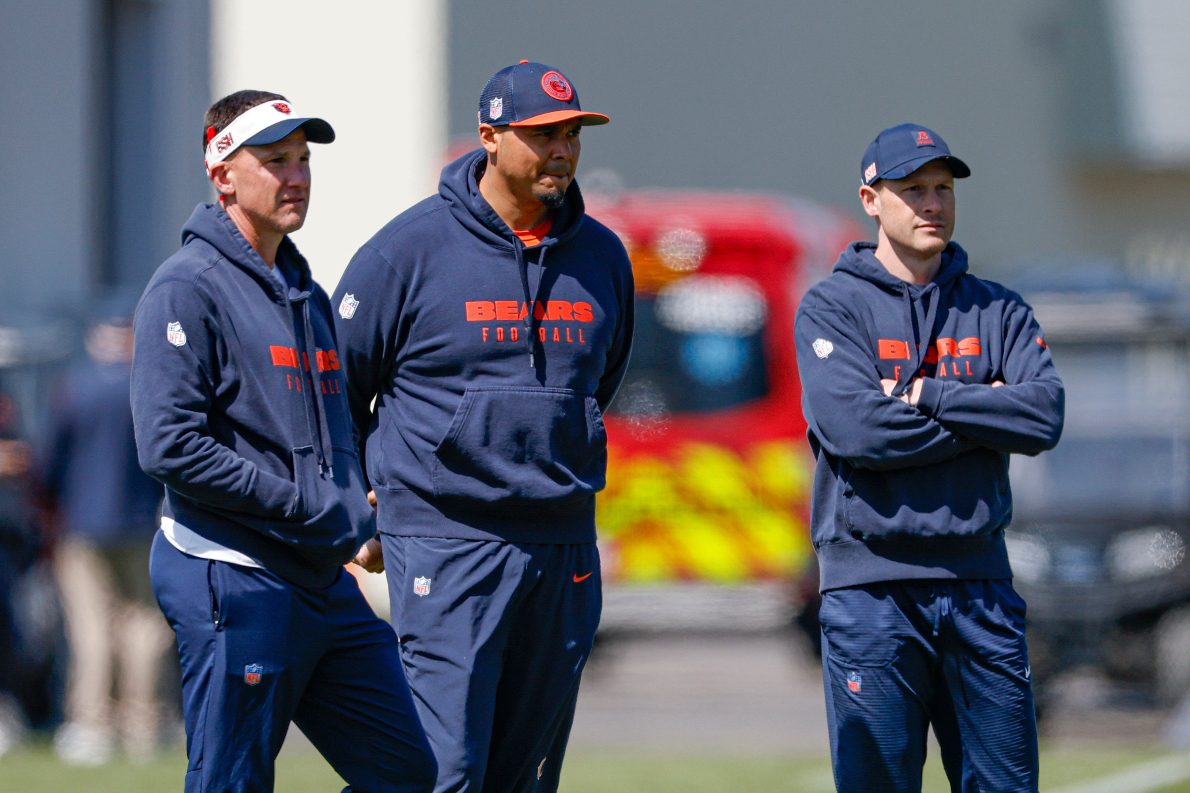 May 9, 2025; Lake Forest, IL, USA; Chicago Bears defensive coordinator Dennis Allen (L), general manager Ryan Poles (C) and head coach Ben Johnson (R) observe during the Rookie Minicamp at Halas Hall.