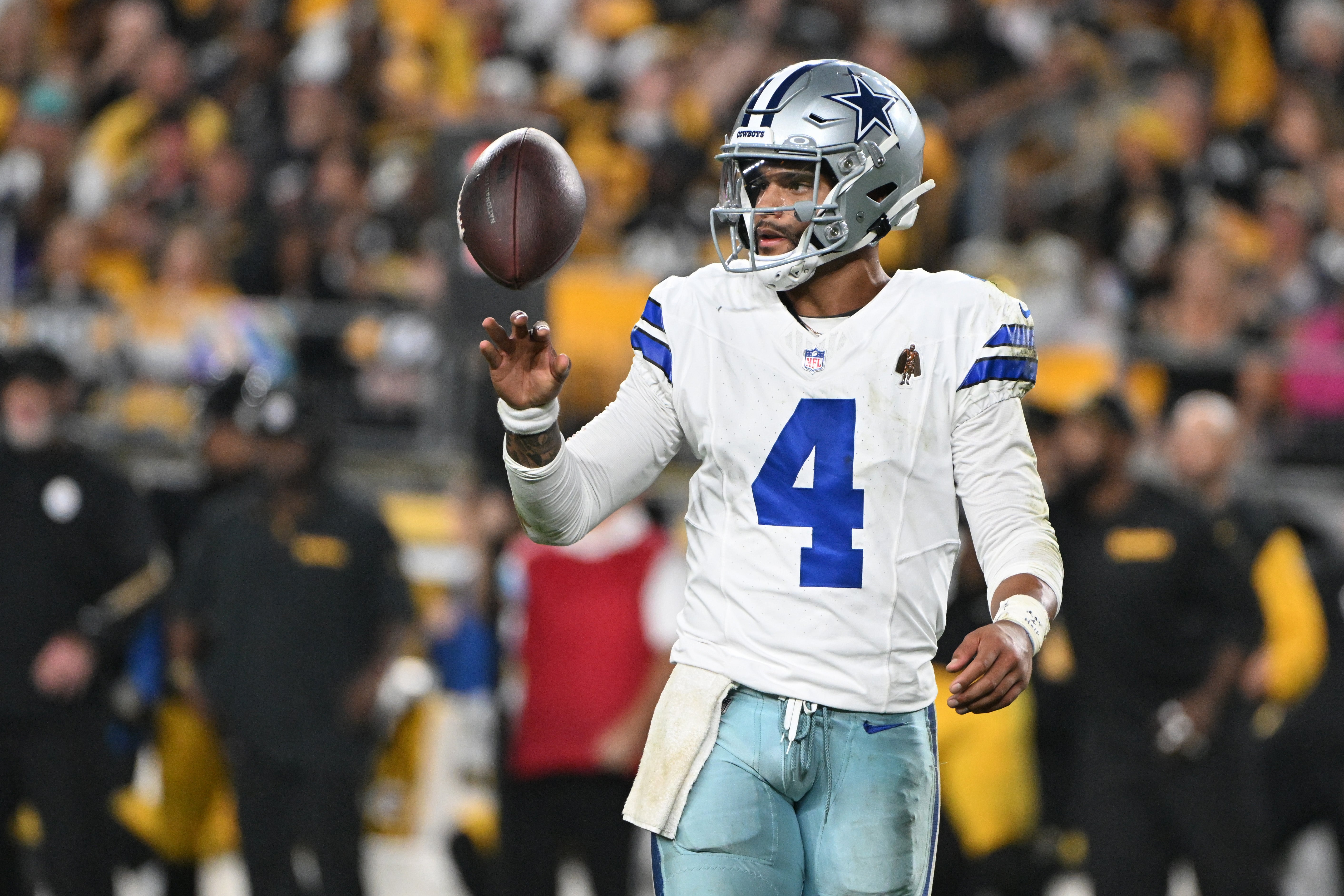Dallas Cowboys quarterback Dak Prescott (4) spins the ball between plays against the Pittsburgh Steelers during the fourth quarter at Acrisure Stadium.