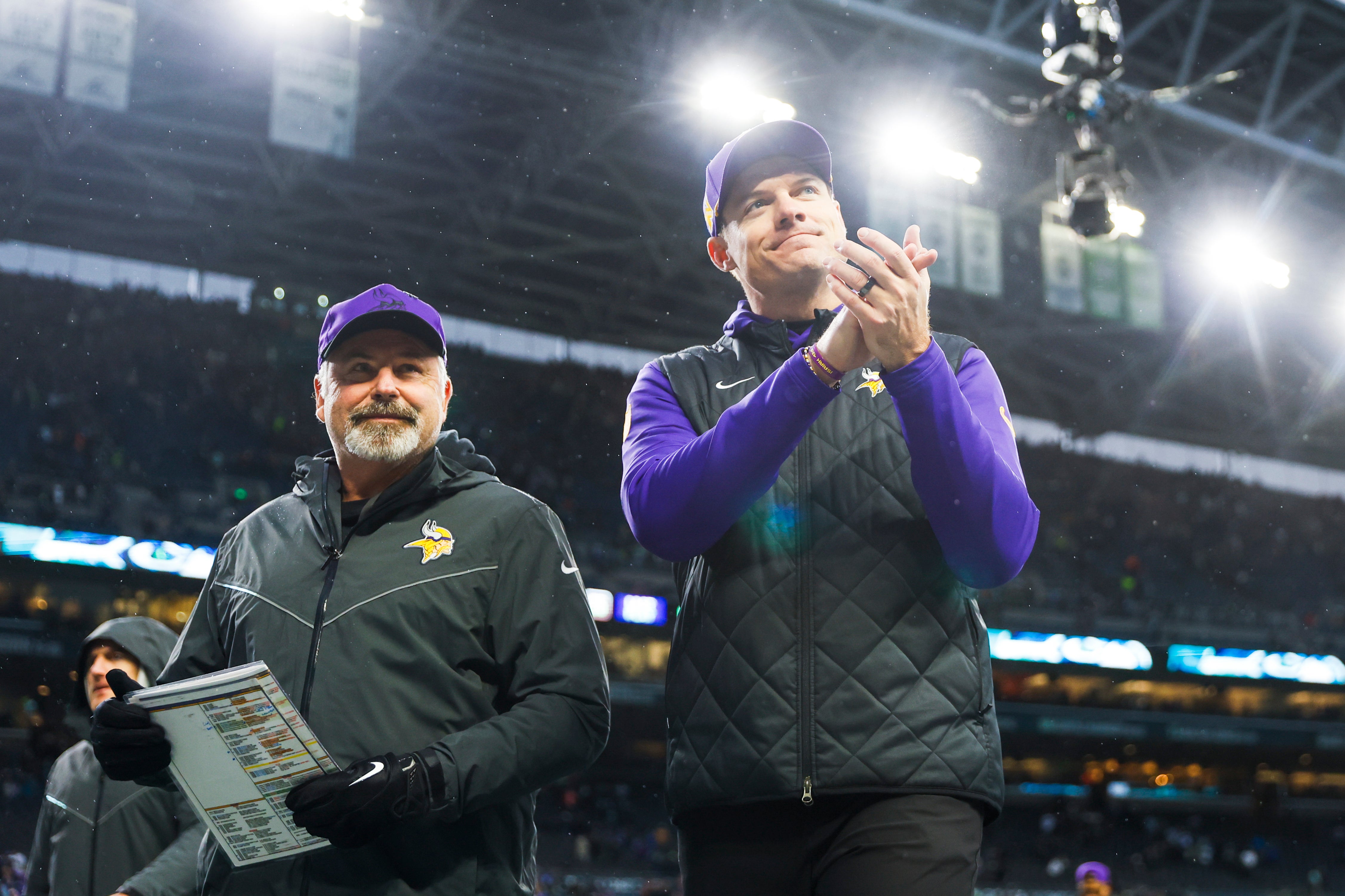 Dec 22, 2024; Seattle, Washington, USA; Minnesota Vikings head coach Kevin O'Connell, right, and linebackers coach Mike Pettine, left, walk to the locker room following a victory against the Seattle Seahawks at Lumen Field.