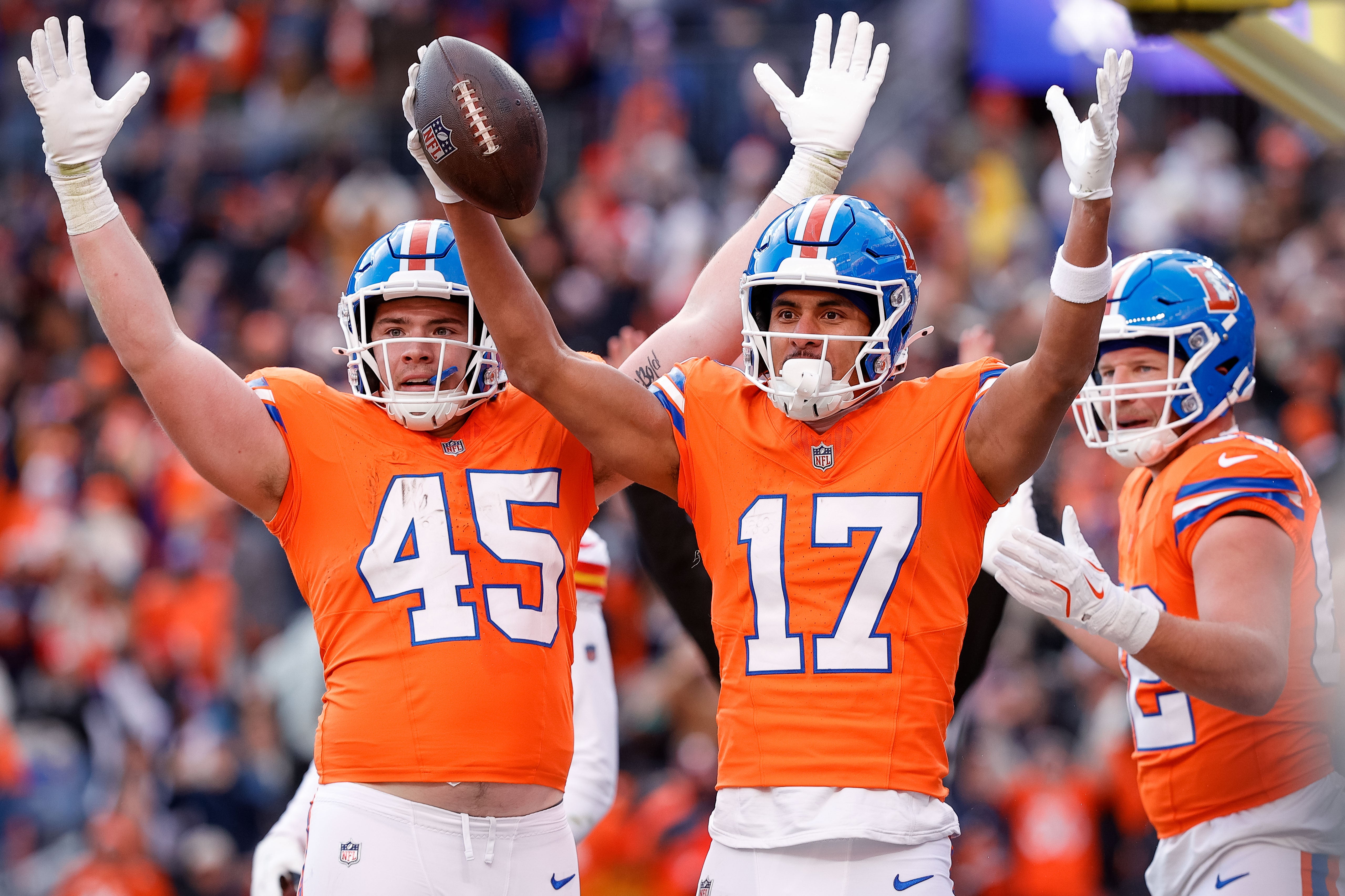 Denver Broncos wide receiver Devaughn Vele (17) celebrates his touchdown with tight end Nate Adkins (45) and tight end Adam Trautman (82) in the second quarter against the Kansas City Chiefs