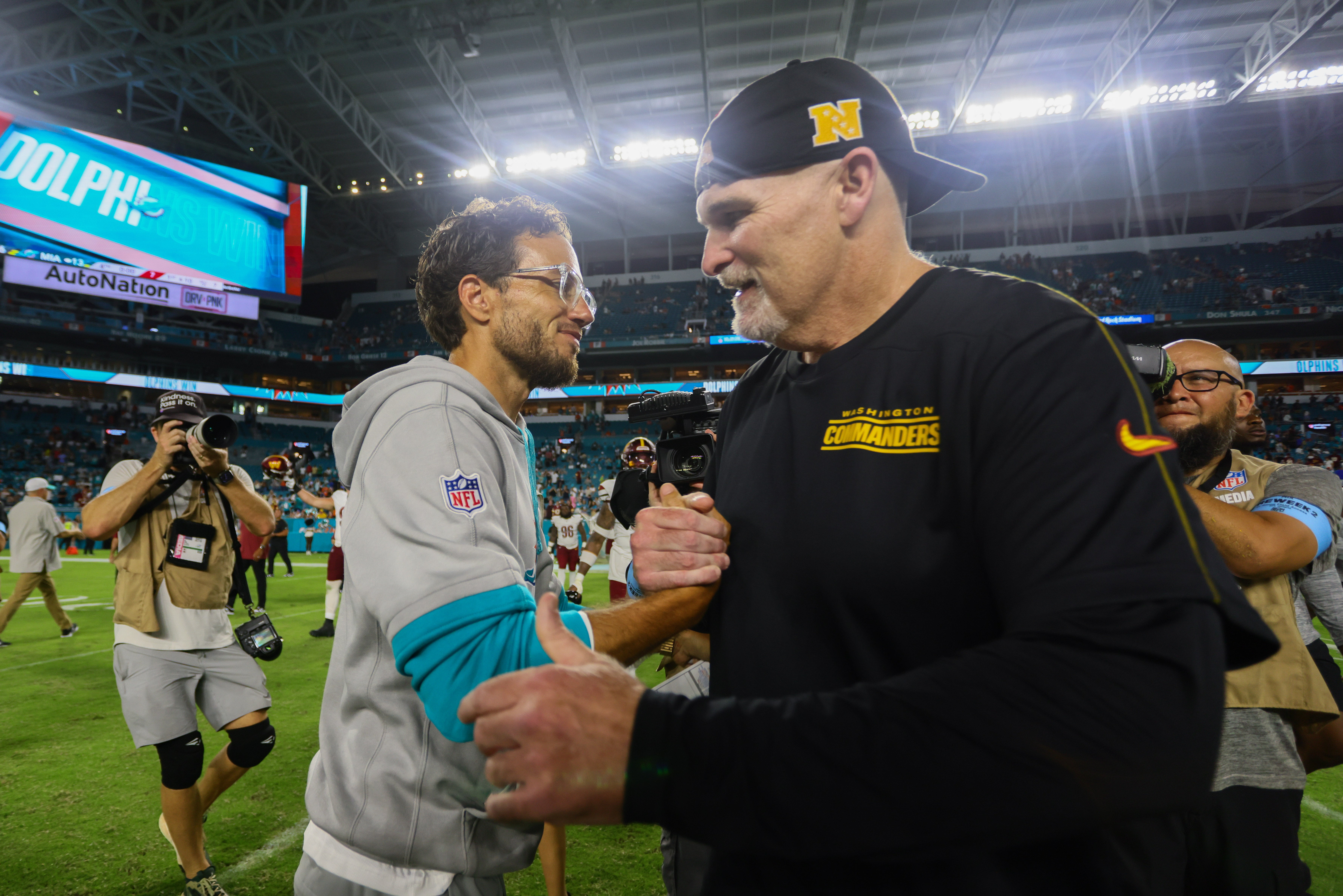 Aug 17, 2024; Miami Gardens, Florida, USA; Miami Dolphins head coach Mike McDaniel and Washington Commanders head coach Dan Quinn shake hands after a preseason game at Hard Rock Stadium.