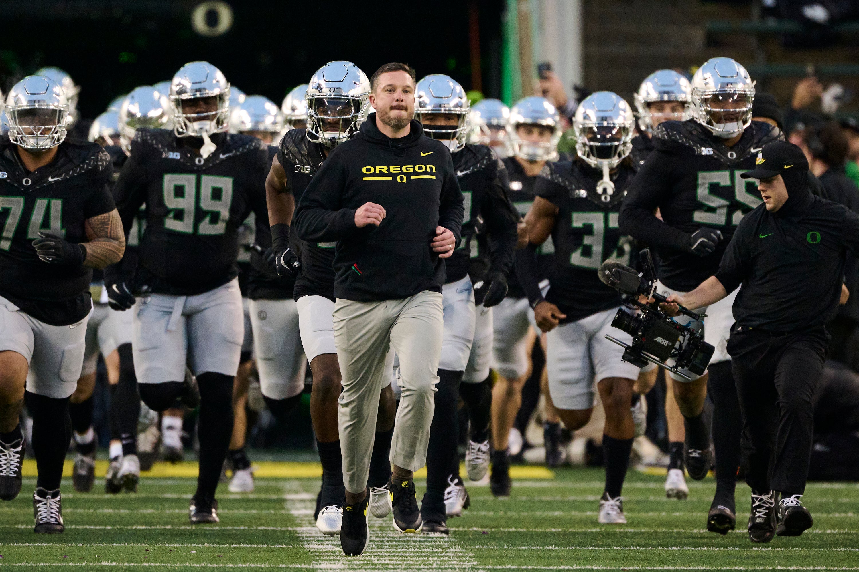 Nov 30, 2024; Eugene, Oregon, USA; Oregon Ducks head coach Dan Lanning runs out with the team before a game against the Washington Huskies at Autzen Stadium.