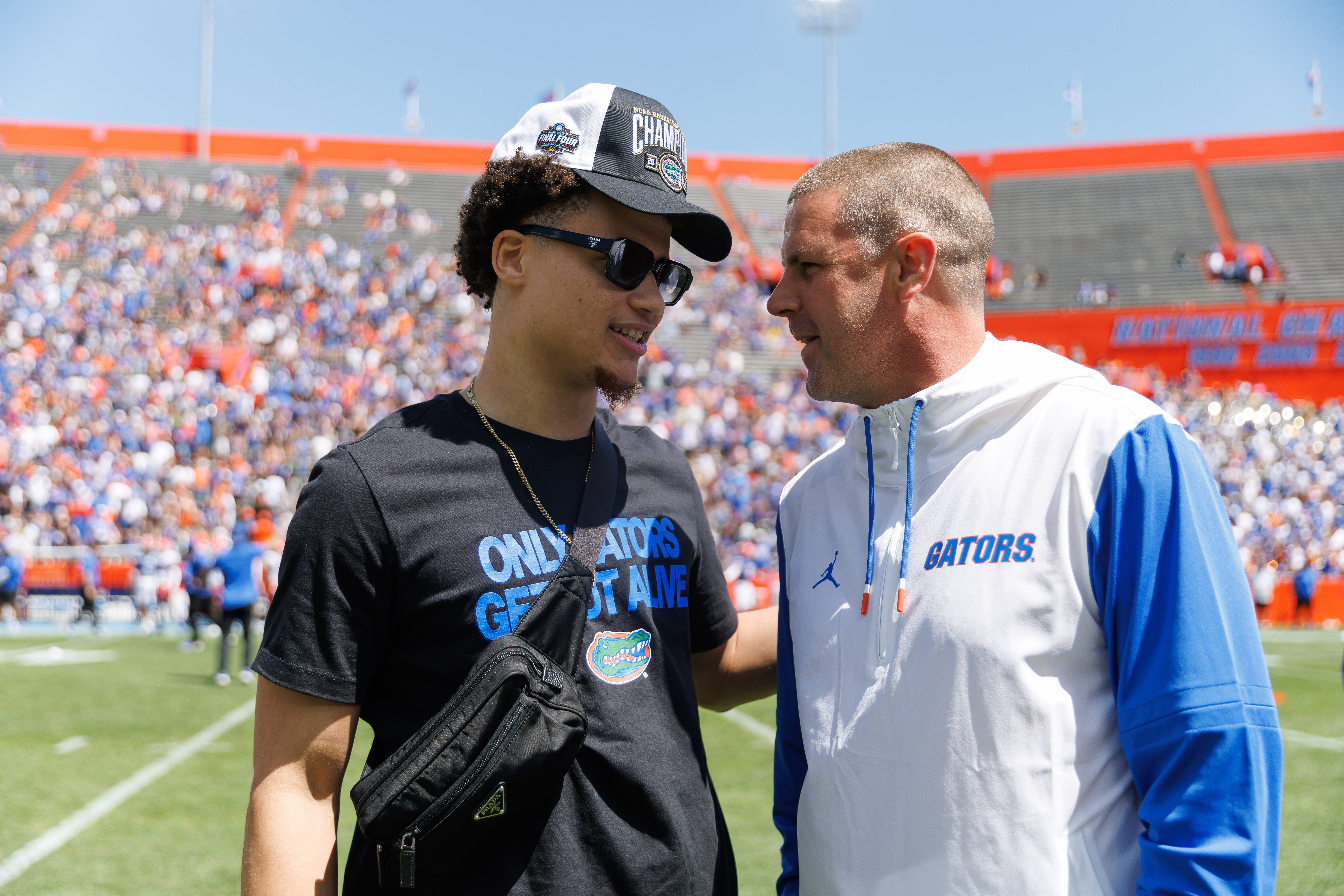 Apr 12, 2025; Gainesville, FL, USA; Florida Gators guard Walter Clayton Jr. (1) talks with Florida Gators head coach Billy Napier during the National Championship celebration at Ben Hill Griffin Stadium.