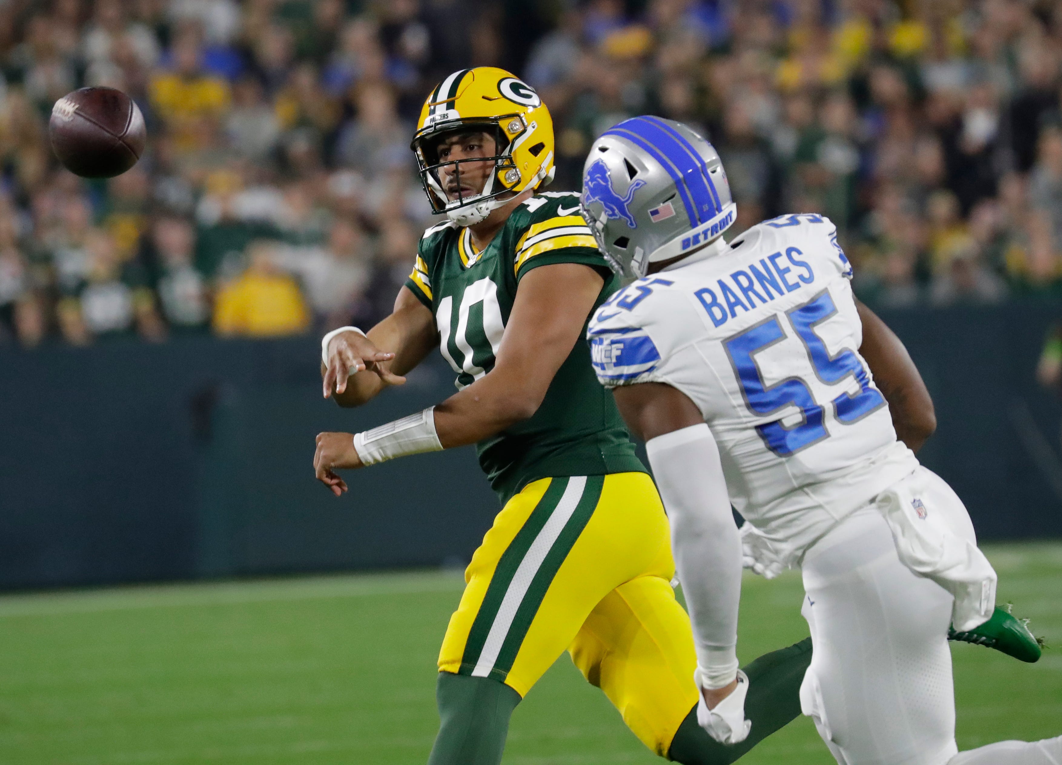 Green Bay Packers quarterback Jordan Love (10) passes the ball against Detroit Lions linebacker Derrick Barnes (55) during their football game Thursday, September 28, 2023, at Lambeau Field in Green Bay