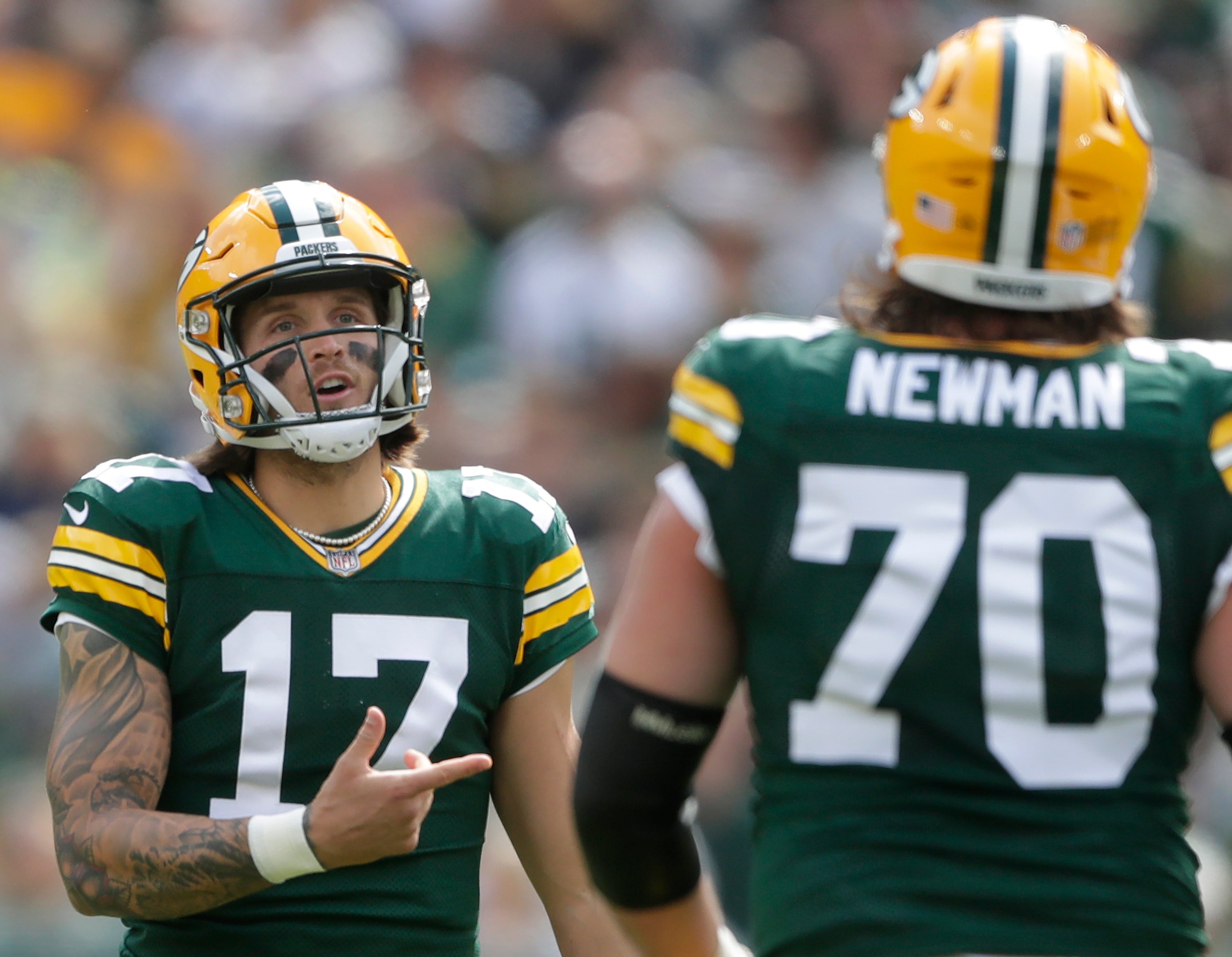 Green Bay Packers quarterback Alex McGough (17) talks with guard Royce Newman (70) following a false start penalty against the Seattle Seahawks during their preseason football game at Lambeau Field. Green Bay defeated Seattle 19-15.