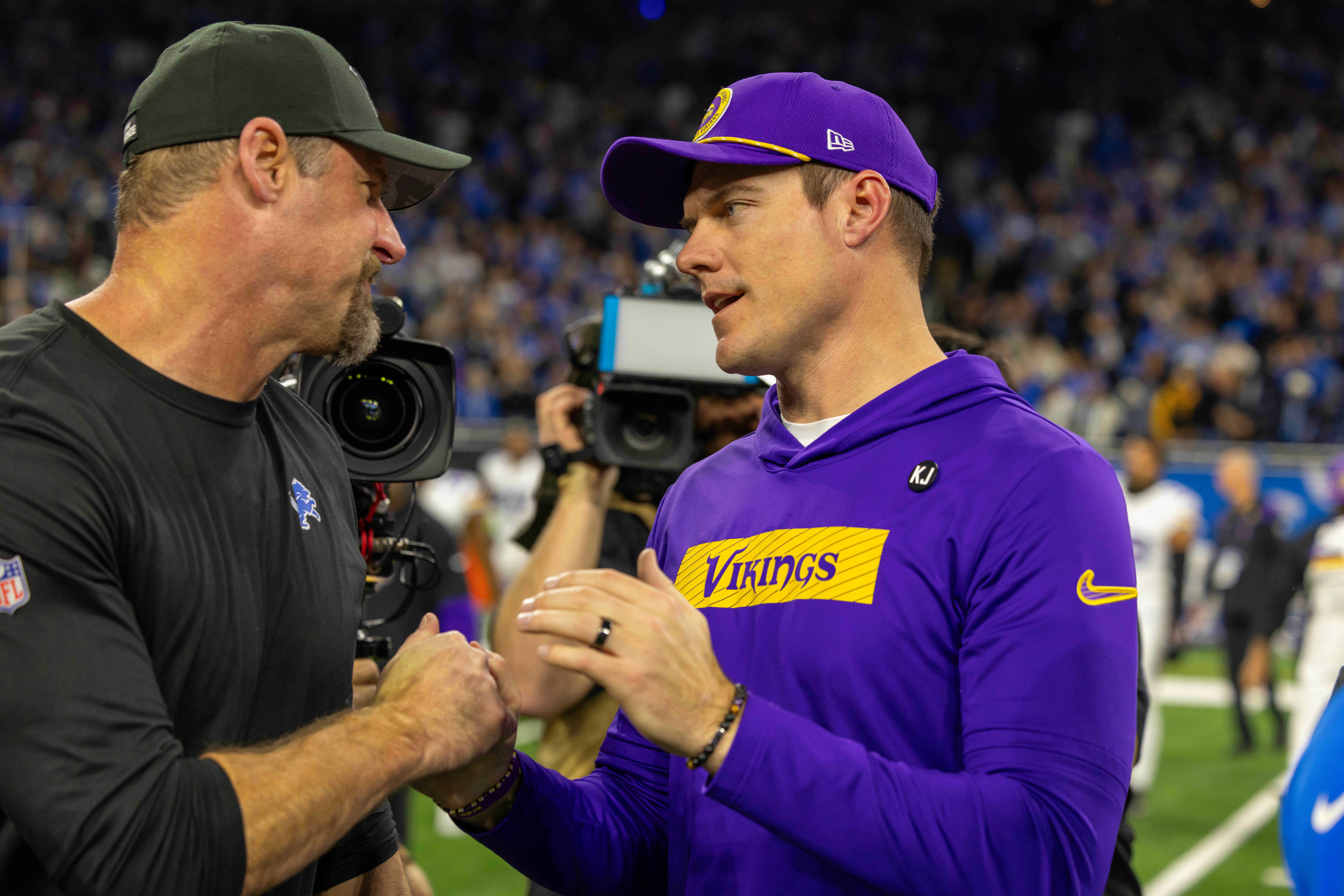 Jan 5, 2025; Detroit, Michigan, USA; Detroit Lions Head Coach Dan Campbell (L) shakes hands with Minnesota Vikings Head Coach Sean McDermott after the game at Ford Field.