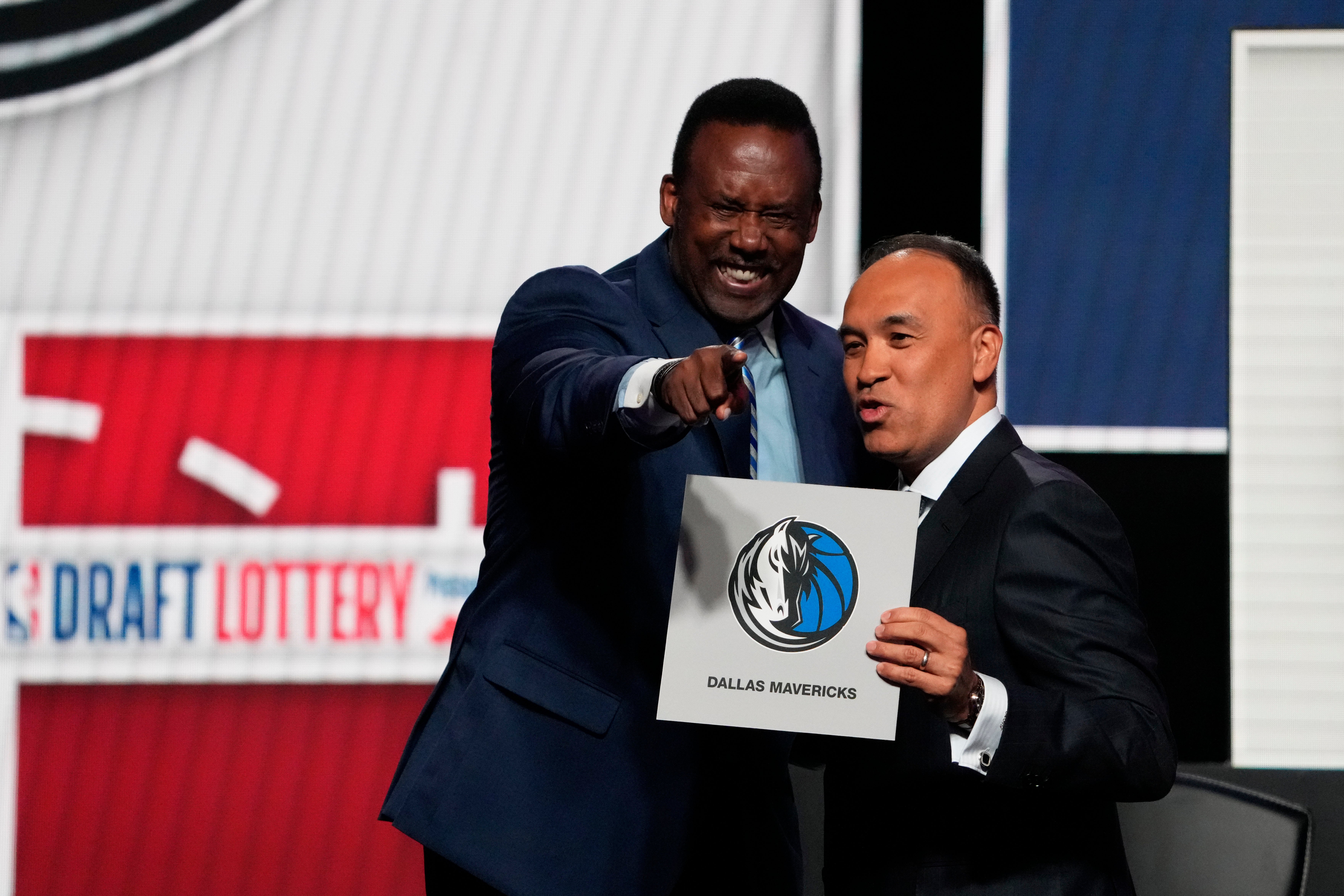 May 12, 2025; Chicago, Illinois, US; Rolando Blackman of the Dallas Mavericks reacts with Mark Tatum NBA Deputy Commissioner after winning the the first pick during the 2025 NBA Draft Lottery at McCormick Place.