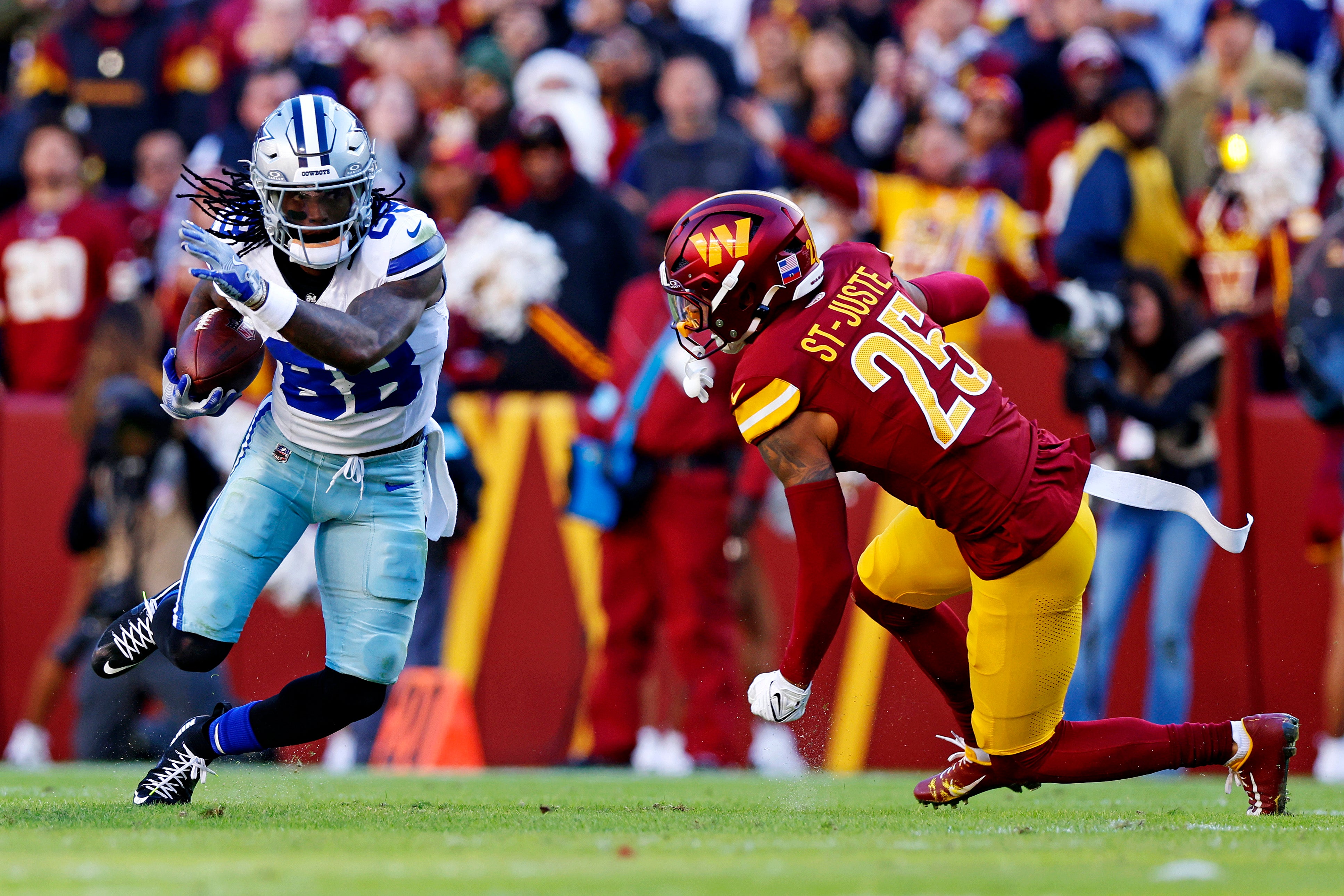 Dallas Cowboys wide receiver CeeDee Lamb (88) runs the ball after a catch against Washington Commanders cornerback Benjamin St-Juste (25) during the second quarter at Northwest Stadium.