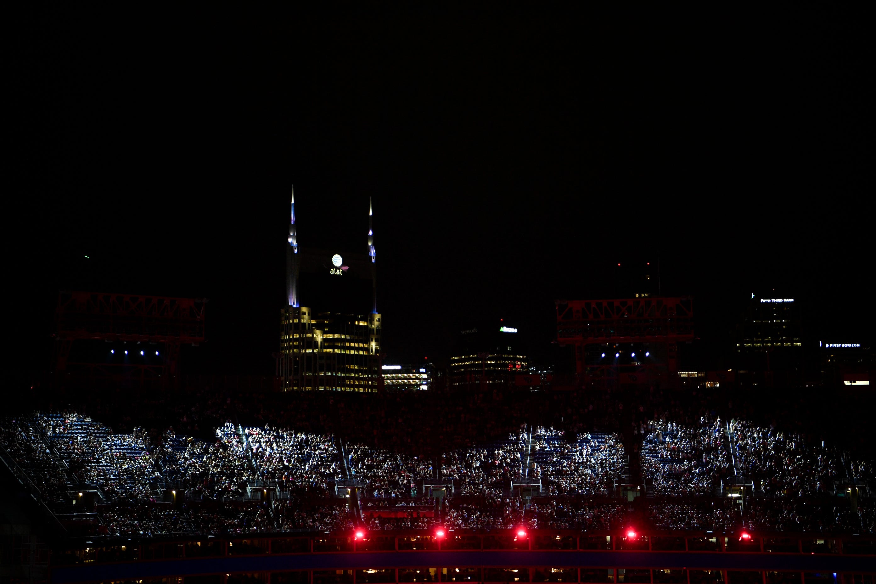 The stadium is lit with the Nashville skyline as Jelly Roll performs during CMA Fest at Nissan Stadium in Nashville, Tenn., Saturday, June 8, 2024.