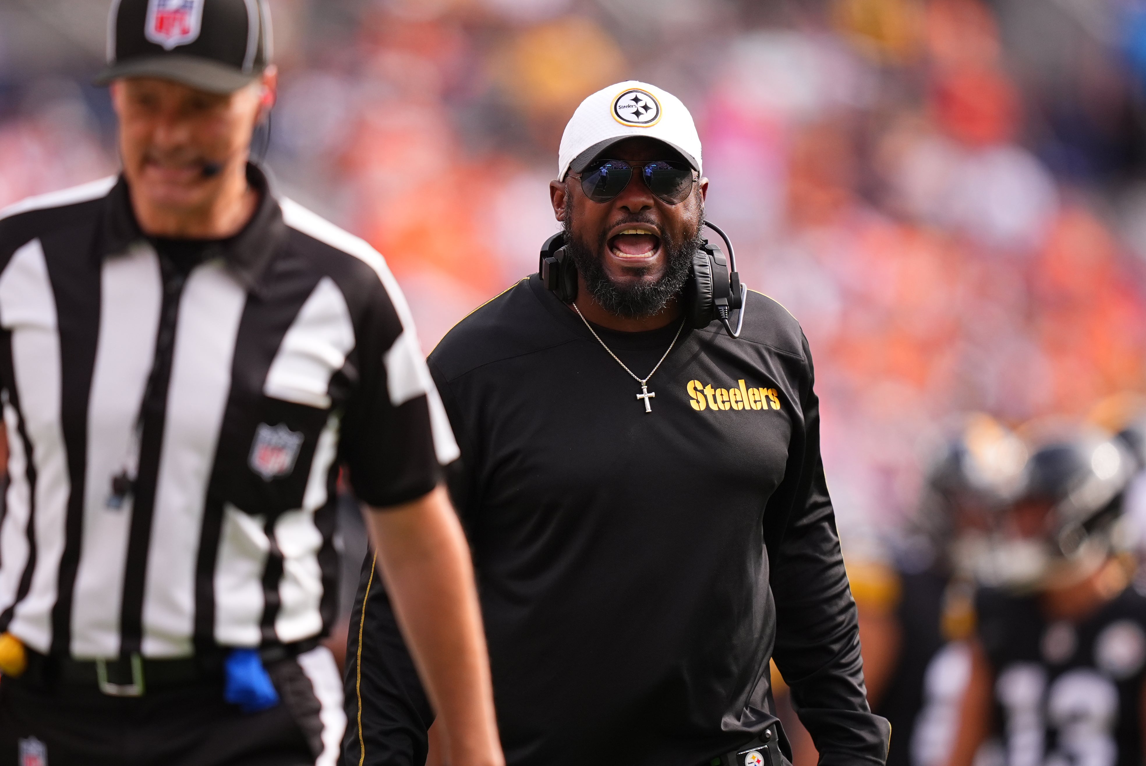 Sep 15, 2024; Denver, Colorado, USA; Pittsburgh Steelers head coach Mike Tomlin yells at down judge Dana McKenzie (8) in the second quarter against the Denver Broncos at Empower Field at Mile High.