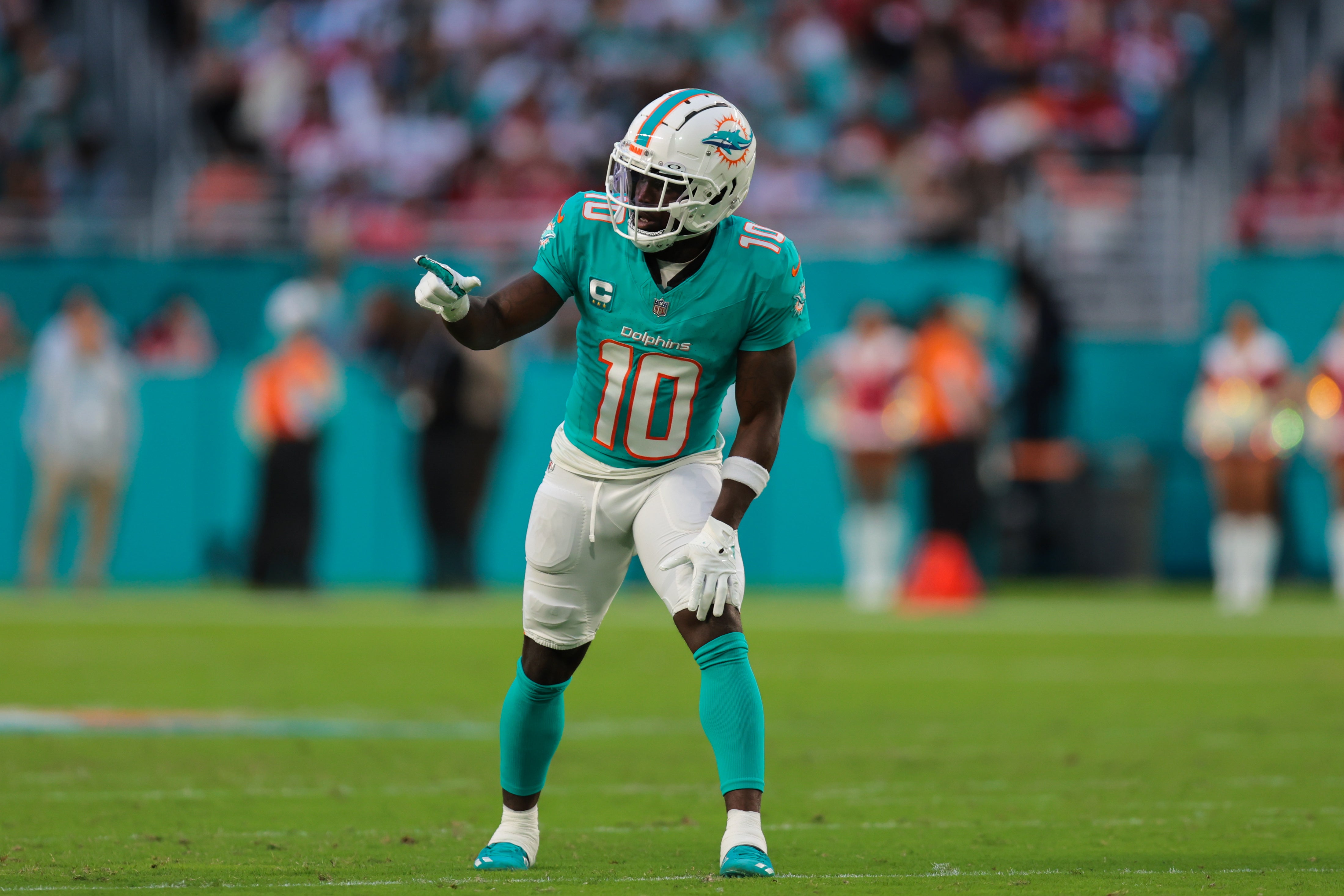 Dec 22, 2024; Miami Gardens, Florida, USA; Miami Dolphins wide receiver Tyreek Hill (10) signals from the line of scrimmage against the San Francisco 49ers during the second quarter at Hard Rock Stadium.