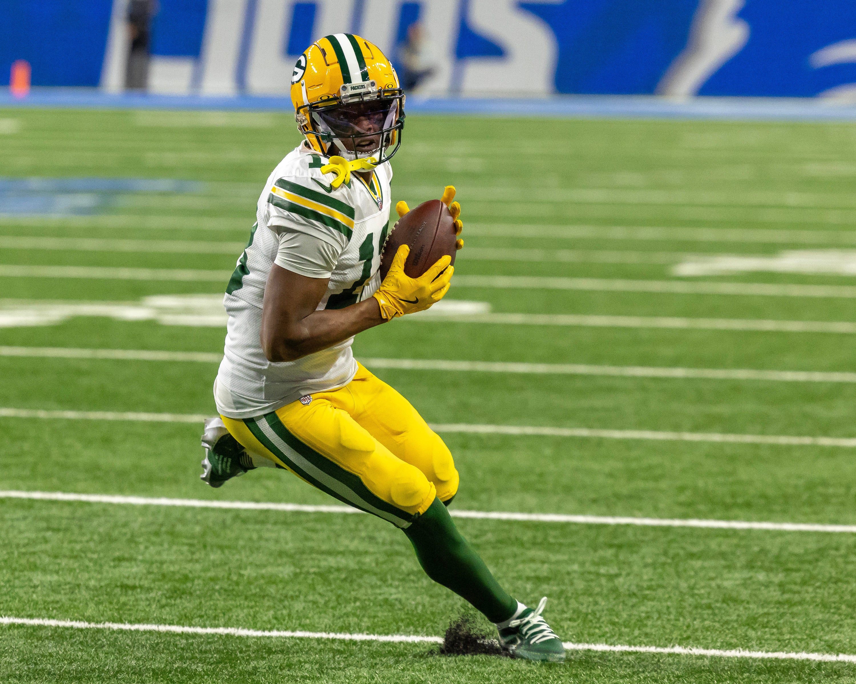 Green Bay Packers wide receiver Dontayvion Wicks (13) catches the ball during the third quarter of the game against the Detroit Lions at Ford Field.