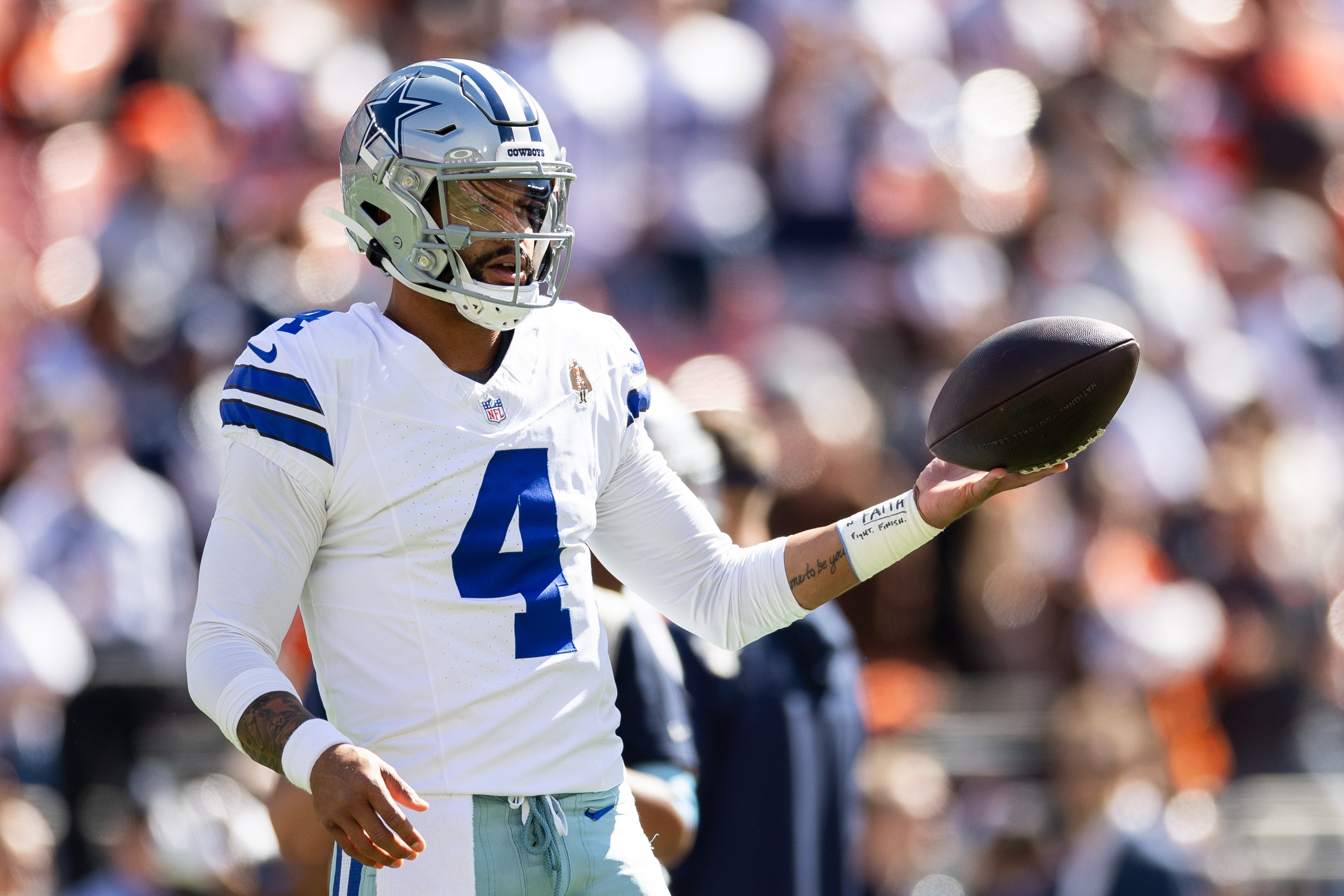 Dallas Cowboys quarterback Dak Prescott (4) warms up before the game against the Cleveland Browns at Huntington Bank Field.