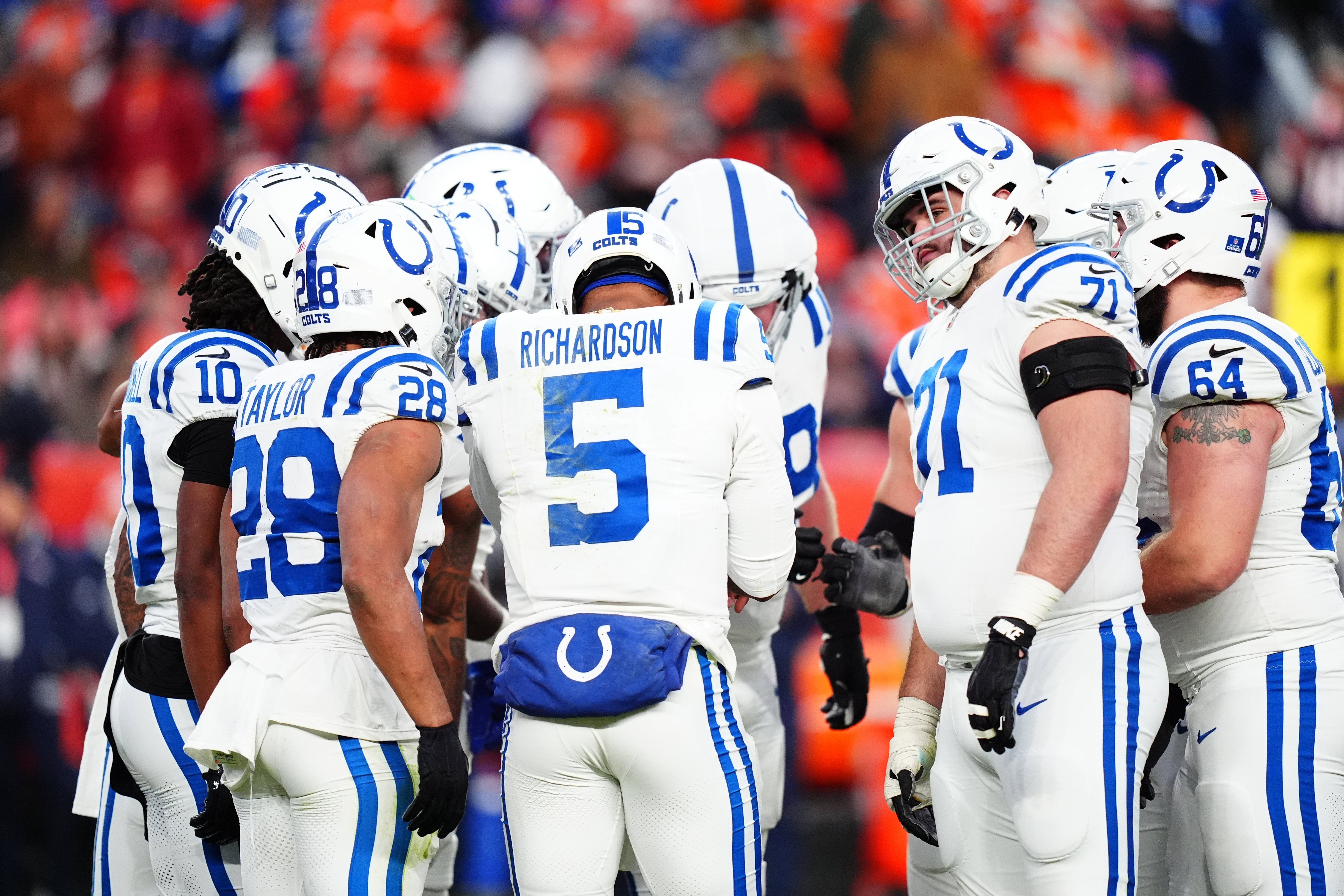 Dec 15, 2024; Denver, Colorado, USA; Members of the Indianapolis Colts offensive squad huddles in the second half against the Denver Broncos at Empower Field at Mile High.